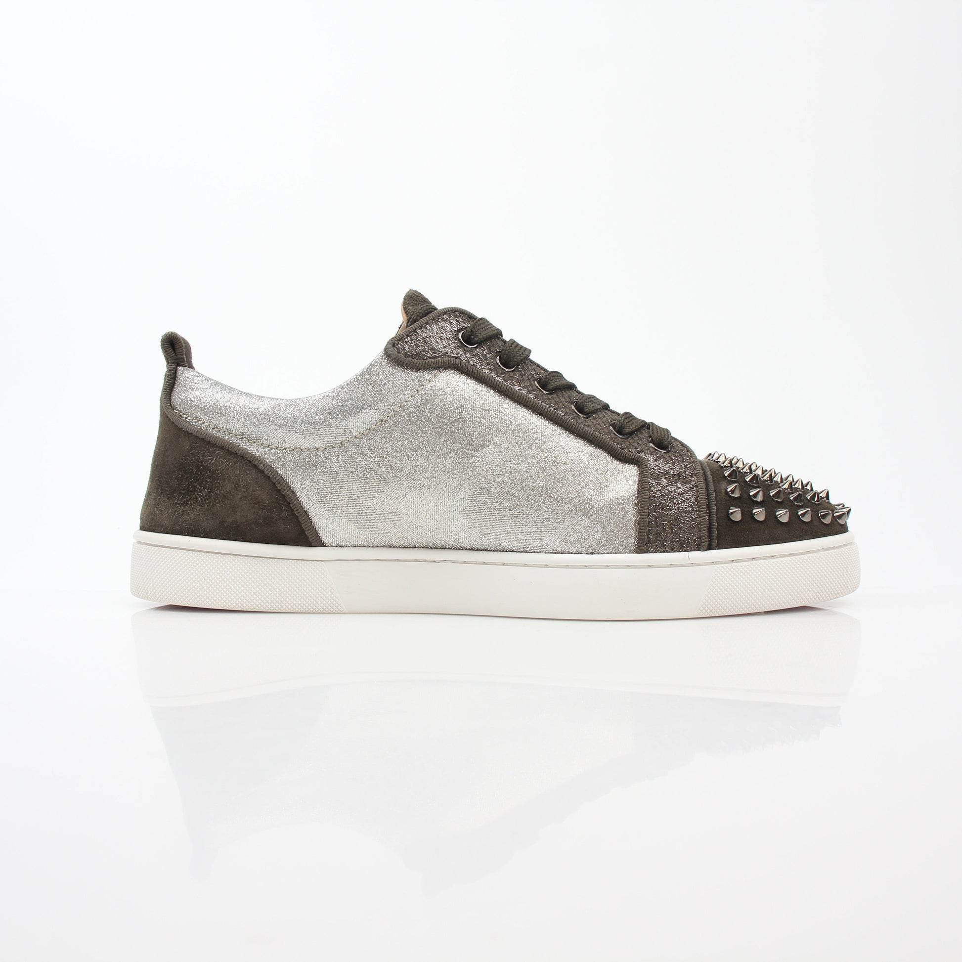 Christian Louboutin Silver Louis Junior Spikes Orlato sneakers with metallic finish and spike details, displayed on a plain background.
