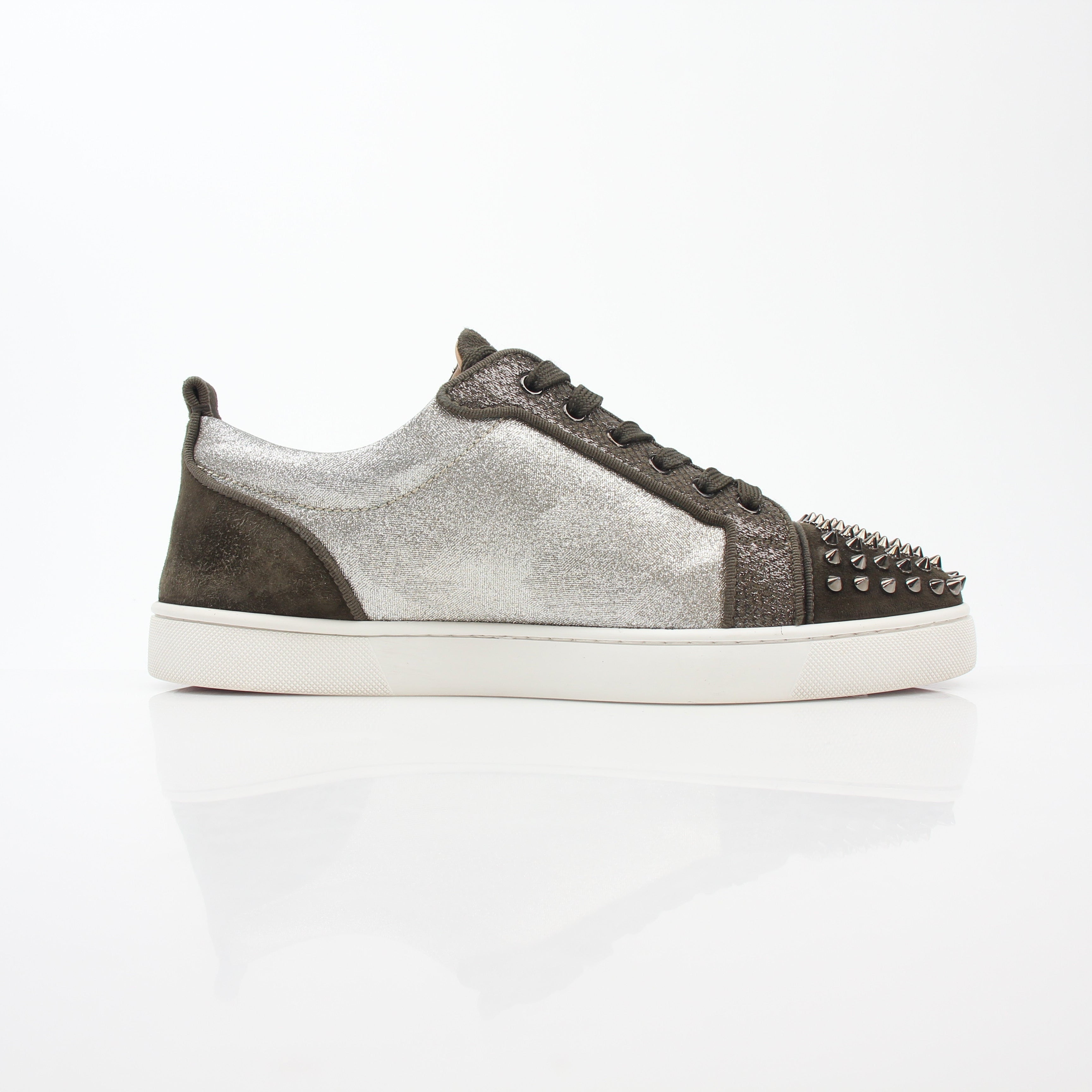 Christian Louboutin Silver Louis Junior Spikes Orlato sneakers with metallic finish and spike details, displayed on a plain background.