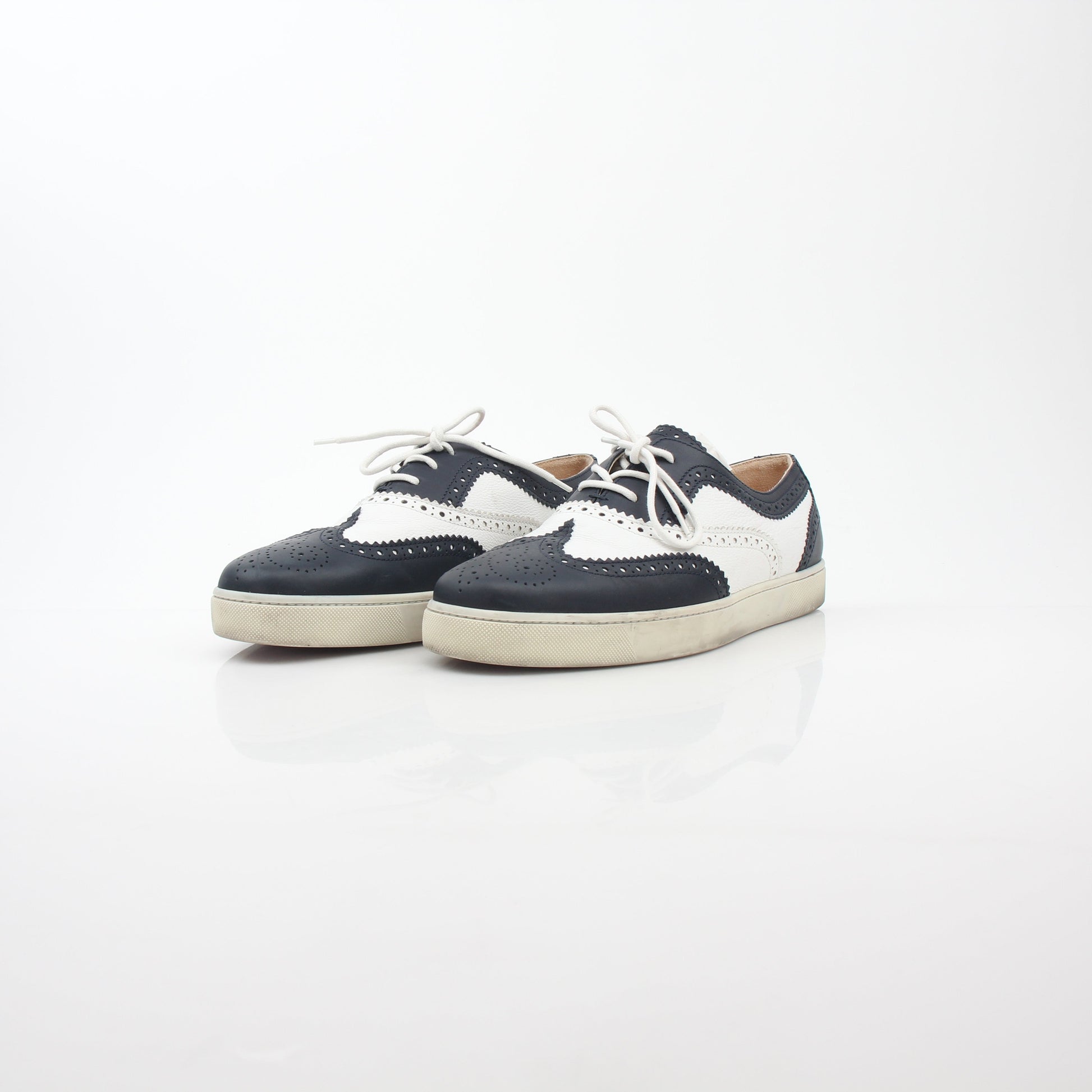 Christian Louboutin Navy and White Golfito Flat Sneakers, stylish shoes with navy and white design, on a clean background.