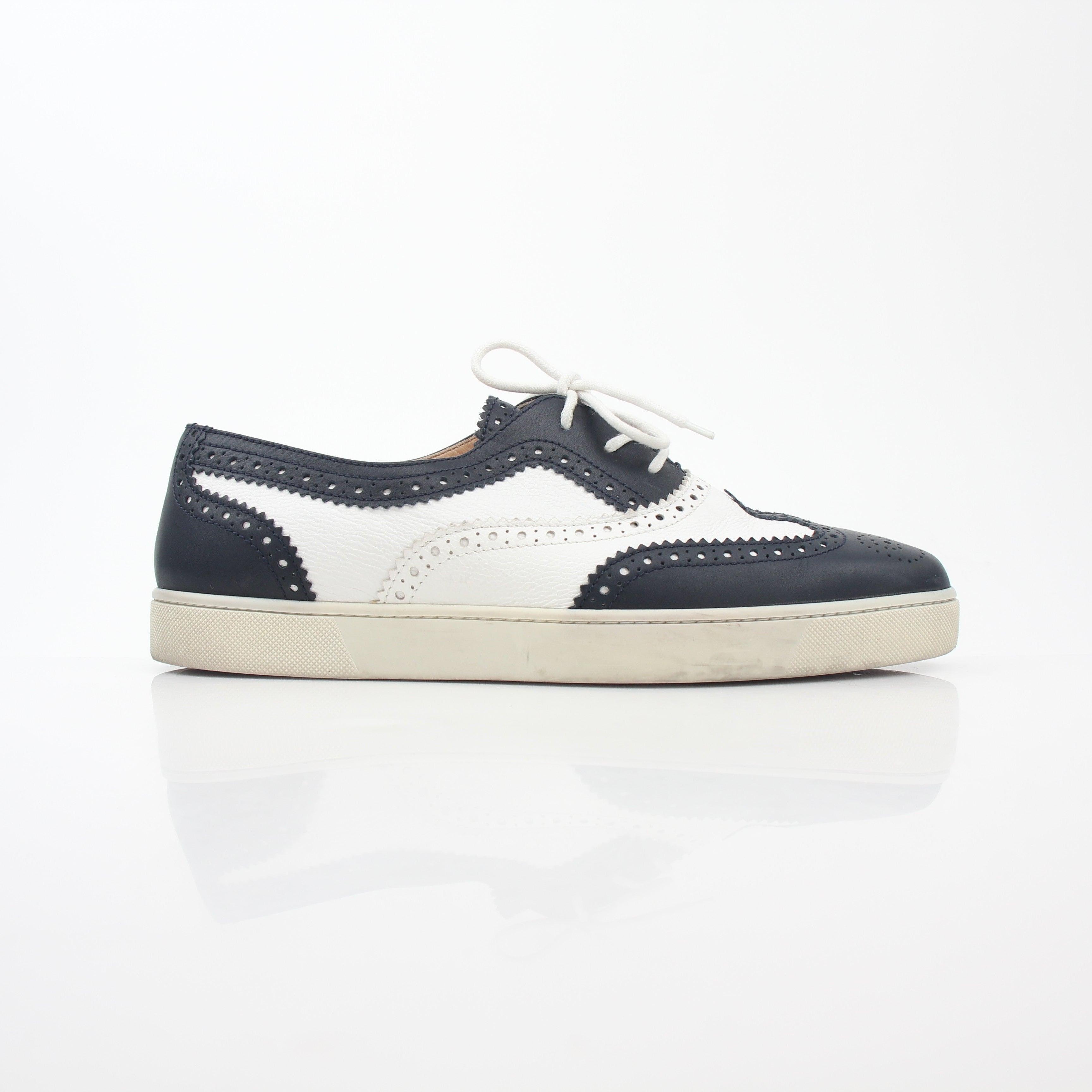 Christian Louboutin Navy and White Golfito flat sneakers with sleek design, white soles, and navy blue accents.