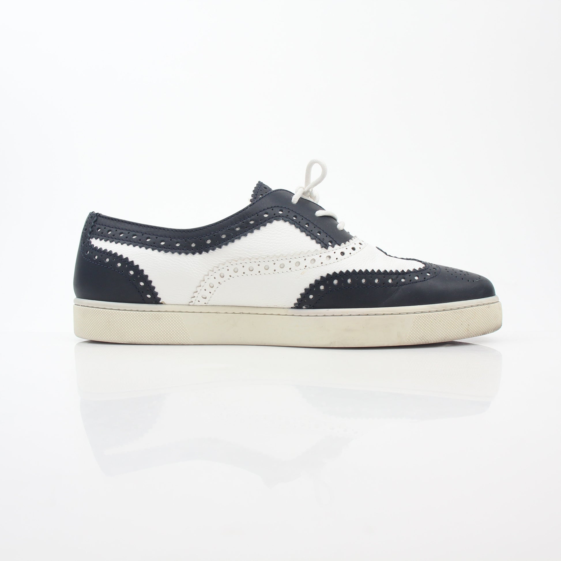 Christian Louboutin Navy and White Golfito Flat Sneakers with signature red sole, stylish slip-on shoes for women.