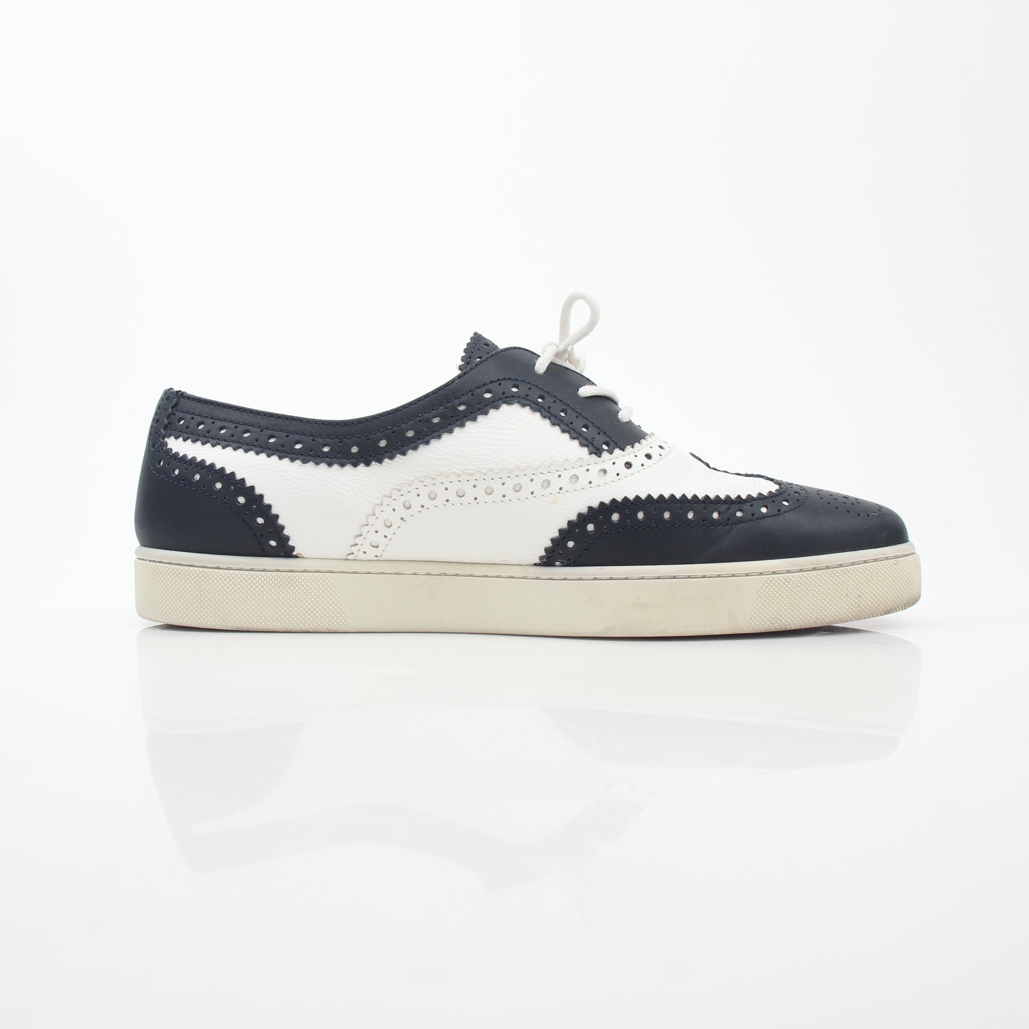 Christian Louboutin Navy and White Golfito Flat Sneakers with signature red sole, stylish slip-on shoes for women.