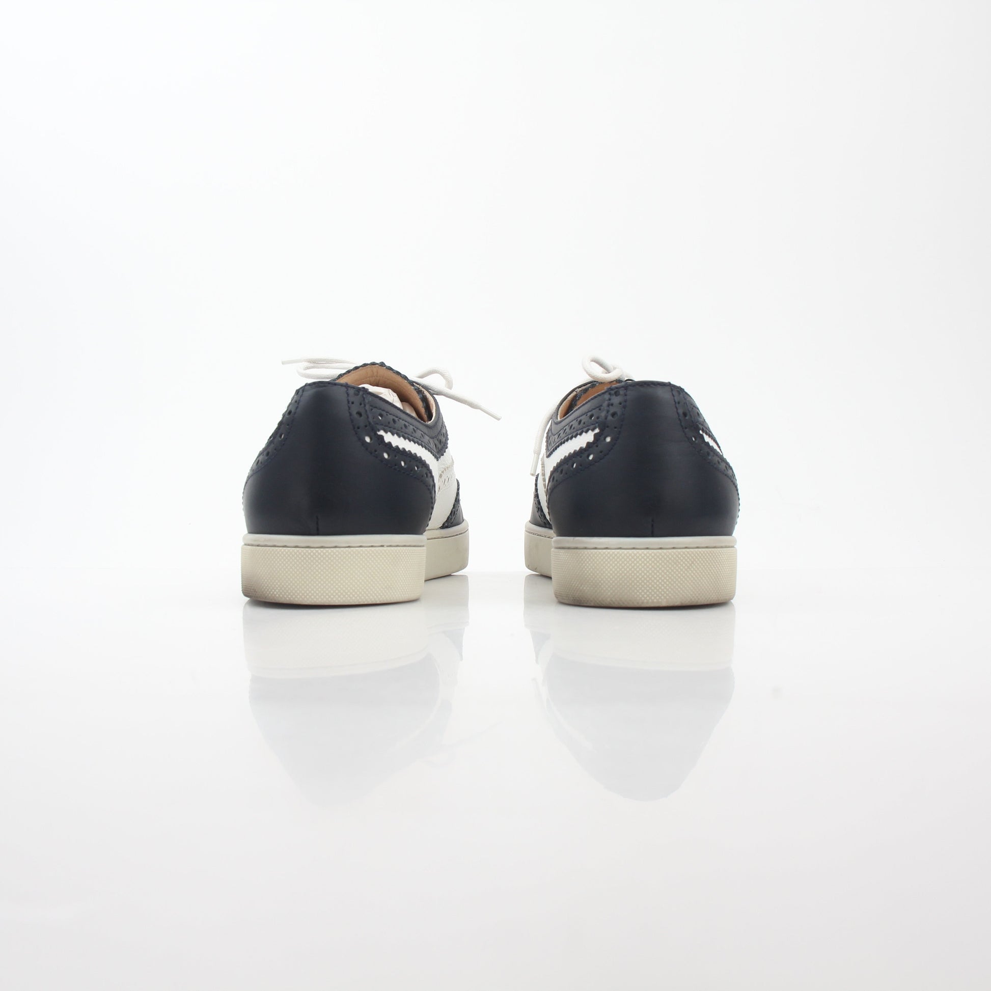 Christian Louboutin Navy and White Golfito flat sneakers, stylish shoes with contrasting colors, featuring signature red sole details.