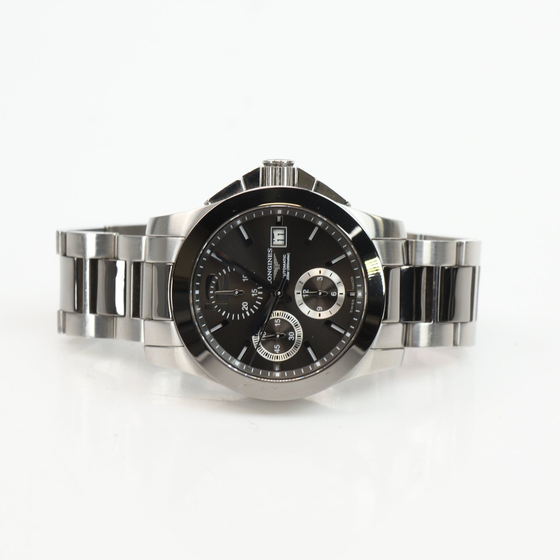 Gold & Beyond Longines automatic chronograph watch with black dial and stainless steel bracelet, showcasing a sleek, luxury timepiece.