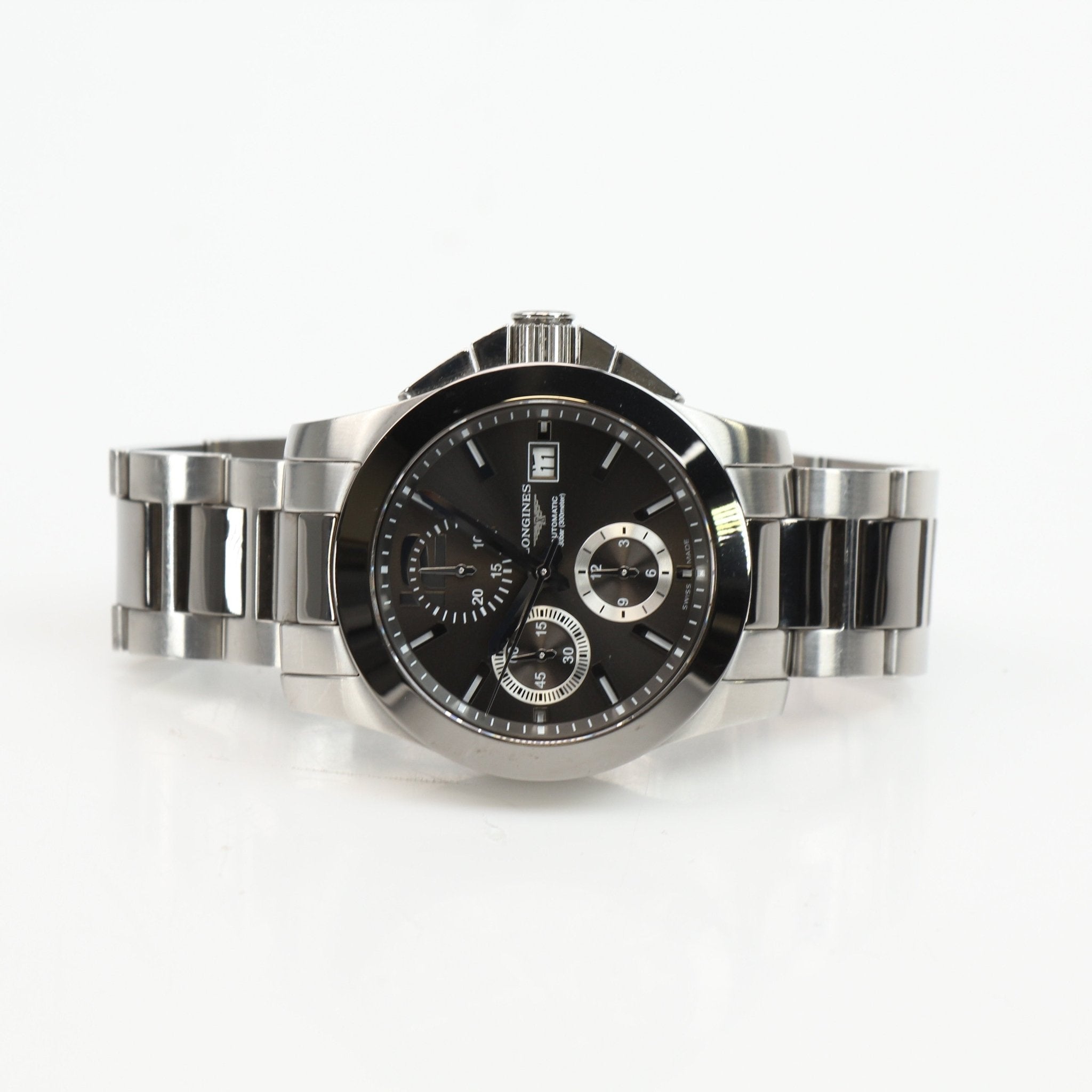 Gold & Beyond Longines automatic chronograph watch with black dial and stainless steel bracelet, showcasing a sleek, luxury timepiece.