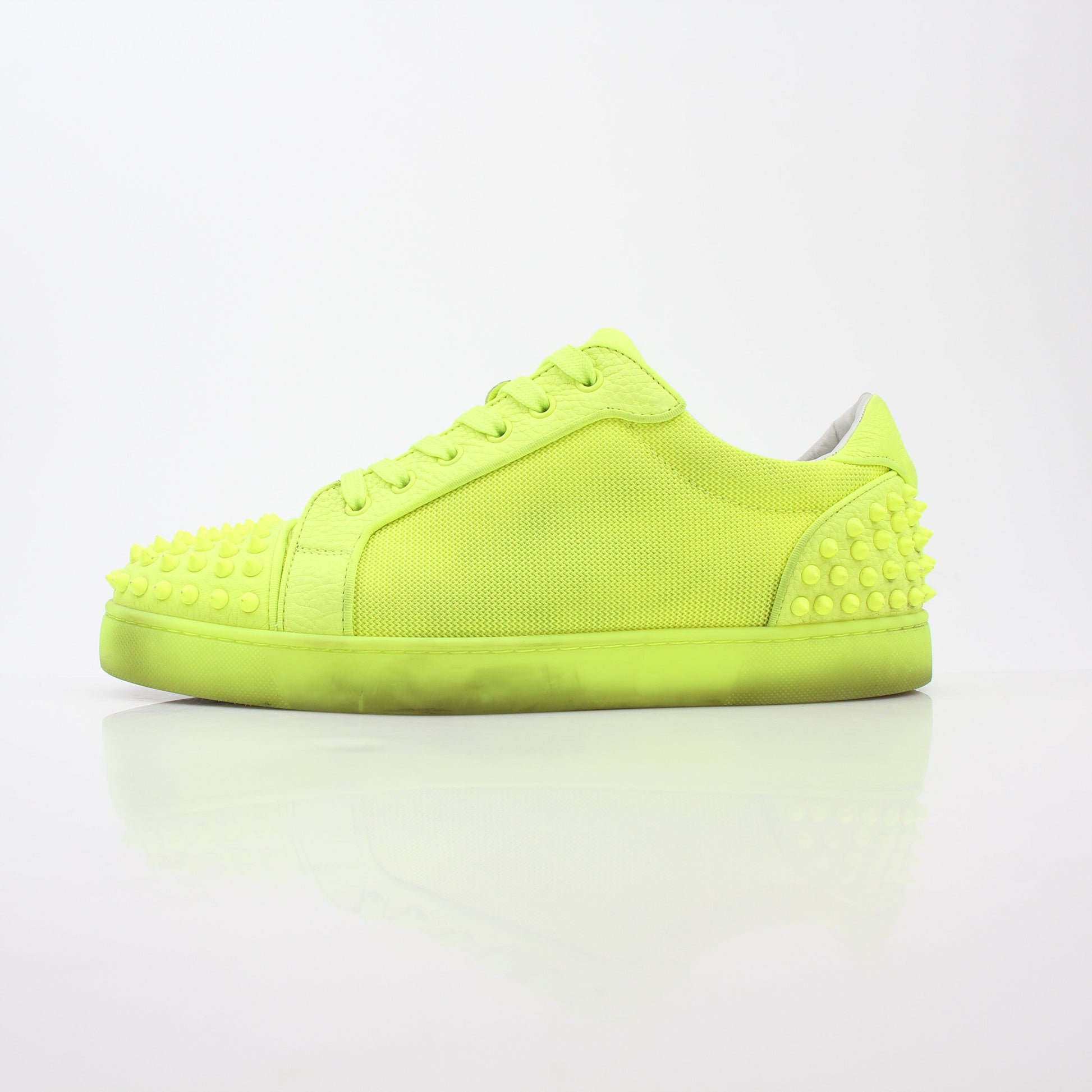 Christian Louboutin Neon Yellow Seavaste 2 Orlato sneakers showing vibrant yellow shoes with black accents and signature red soles.