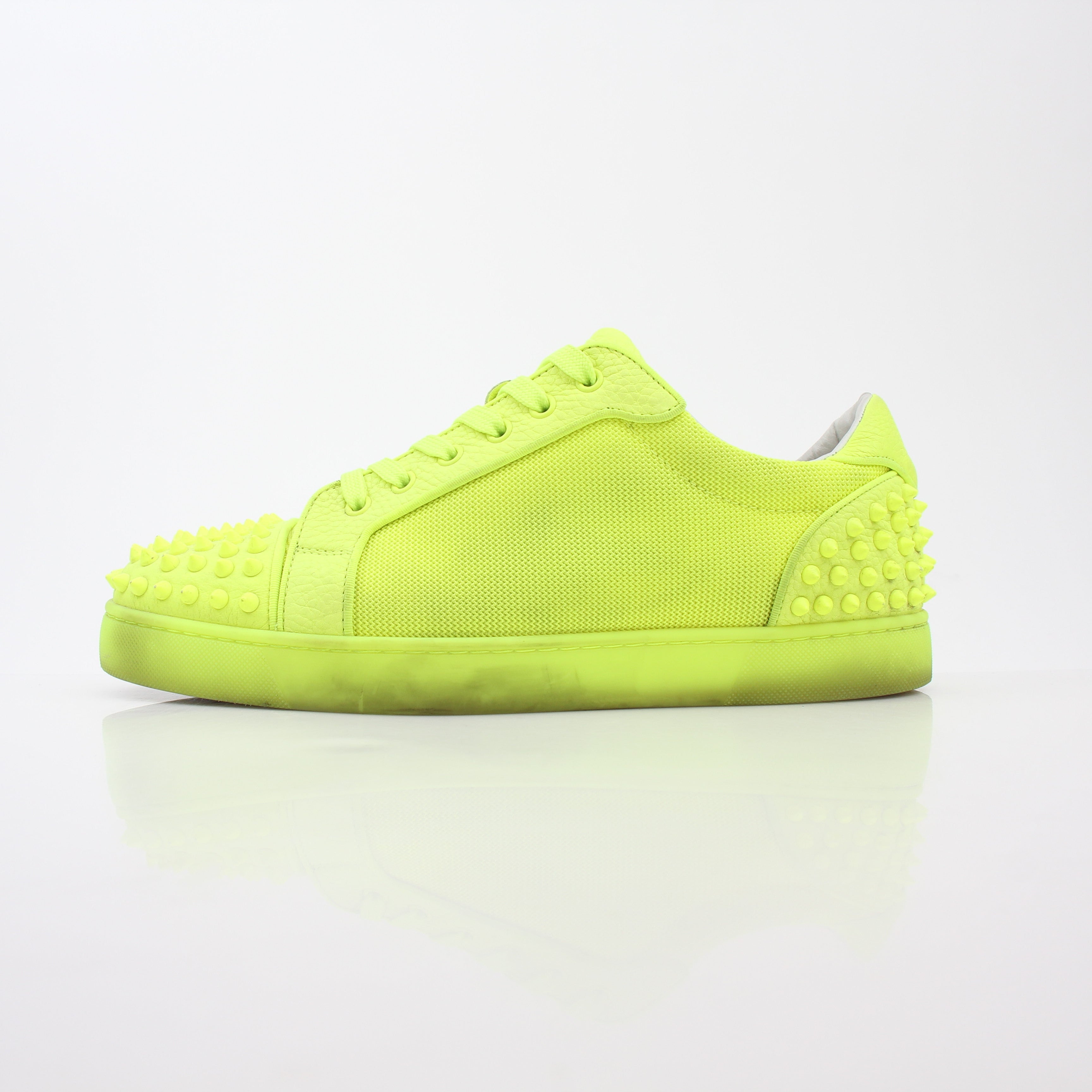 Christian Louboutin Neon Yellow Seavaste 2 Orlato sneakers showing vibrant yellow shoes with black accents and signature red soles.