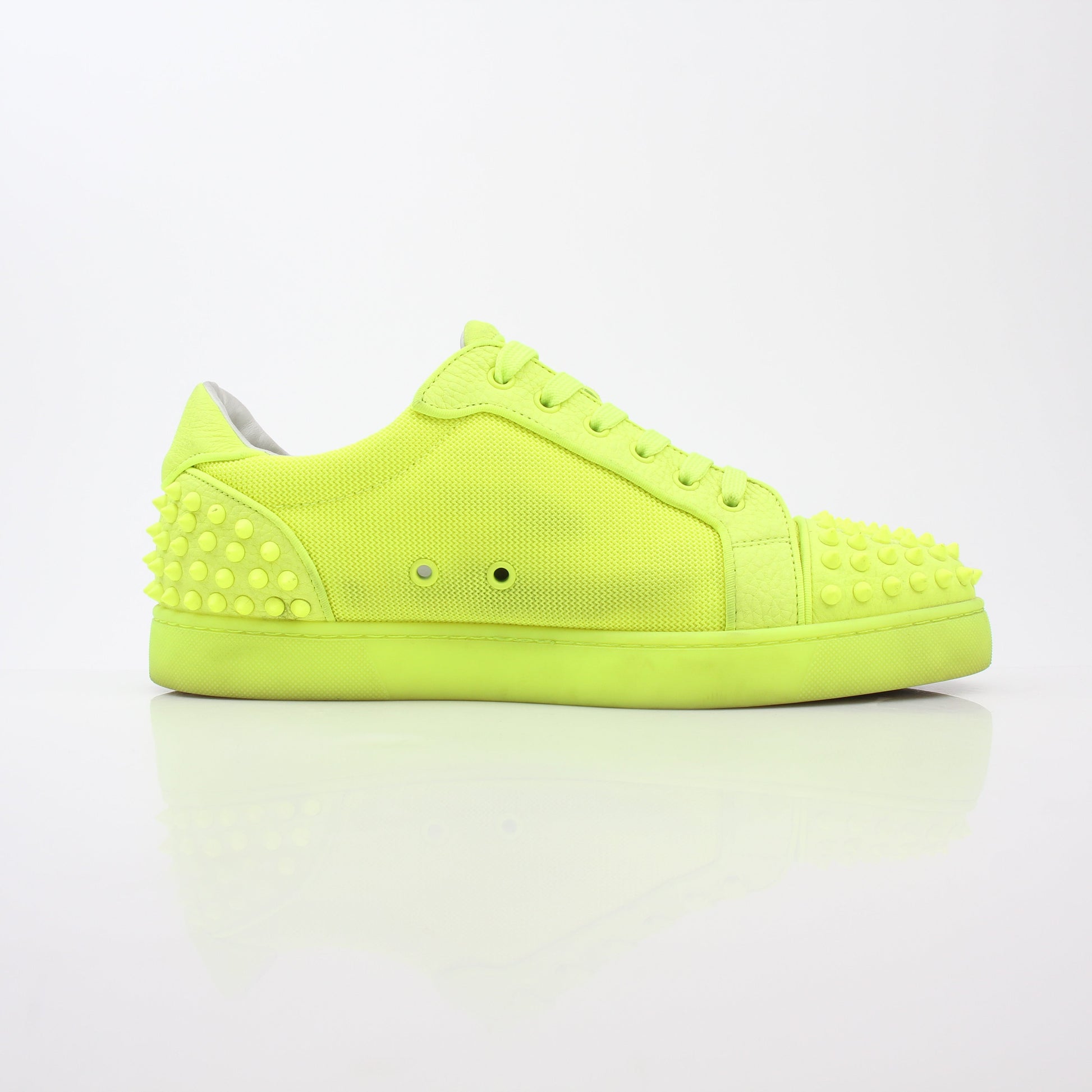 Christian Louboutin Neon Yellow Seavaste 2 Orlato sneakers with black accents and signature red soles, displayed on a white background.