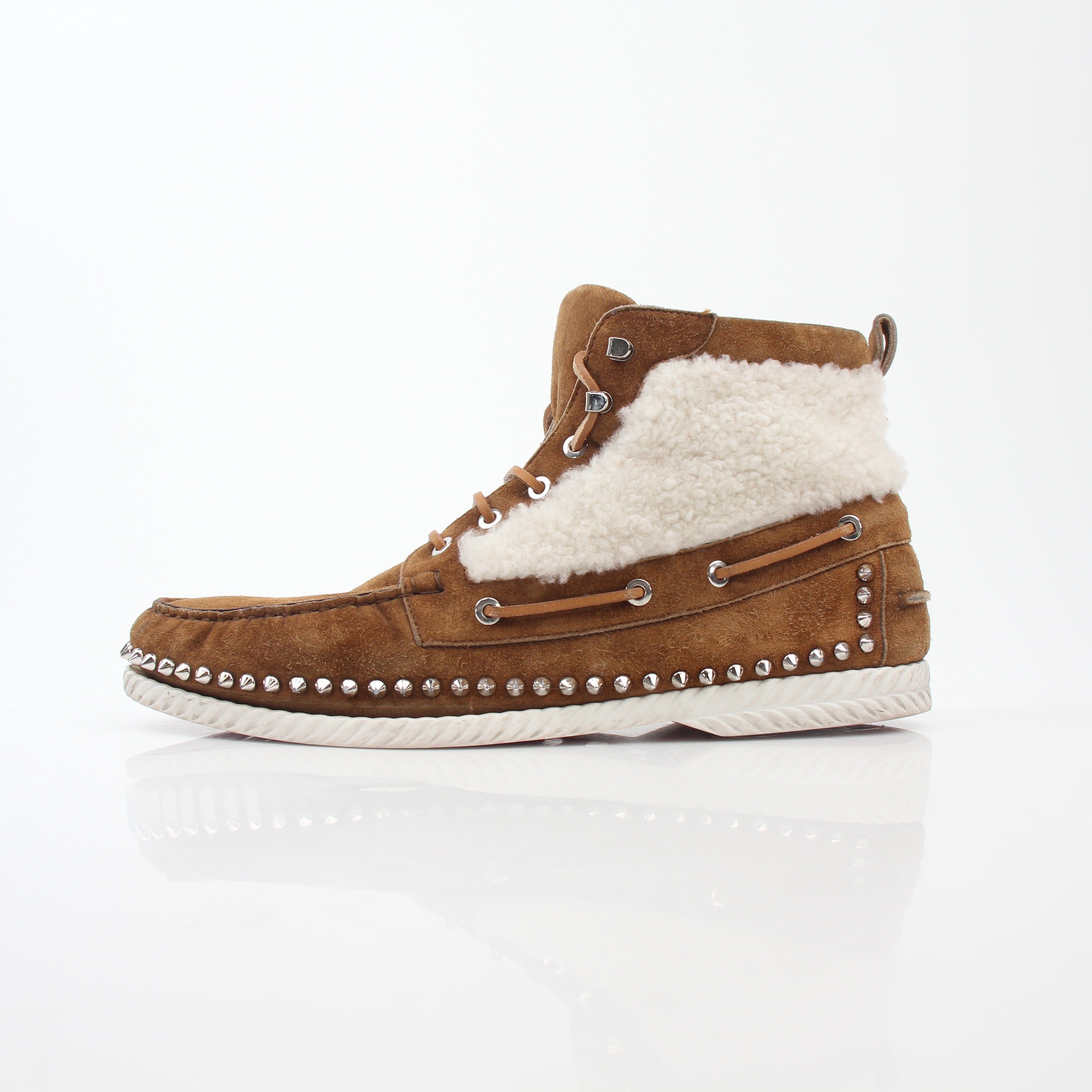 Christian Louboutin Steckel flat shearling boots with black leather and shearling lining, featuring signature red soles.
