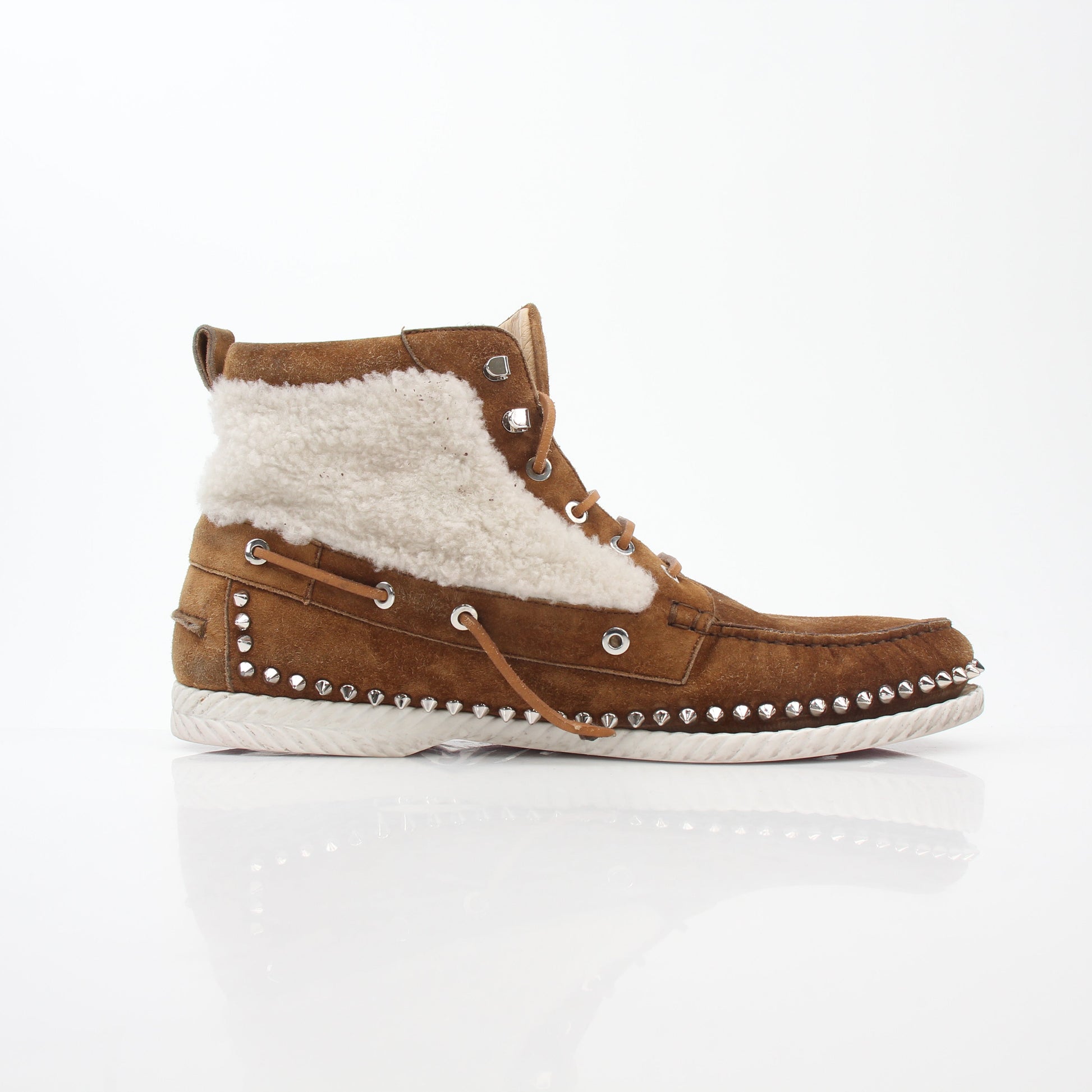 Christian Louboutin shearling flat boots with ankle strap and black leather finish, showcasing luxurious design and craftsmanship.