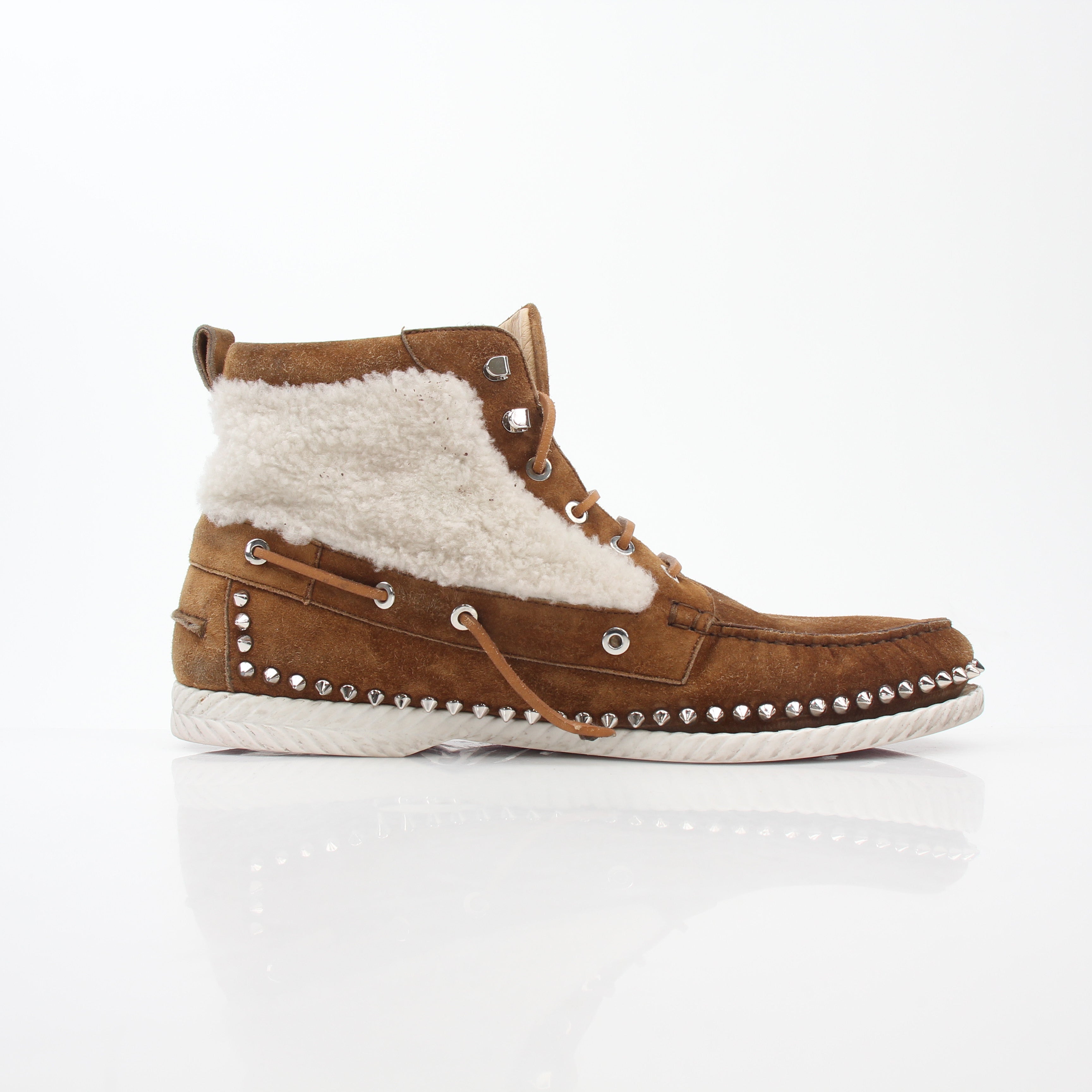 Christian Louboutin shearling flat boots with ankle strap and black leather finish, showcasing luxurious design and craftsmanship.