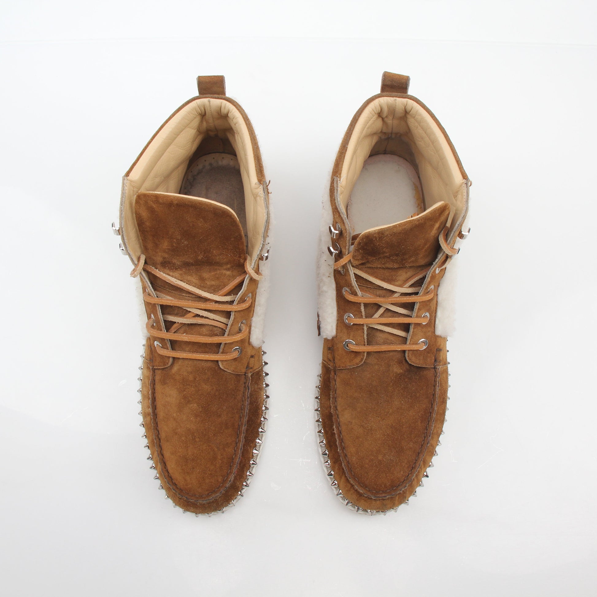 Christian Louboutin Steckel flat shearling boots in black with shearling lining and sleek leather exterior.
