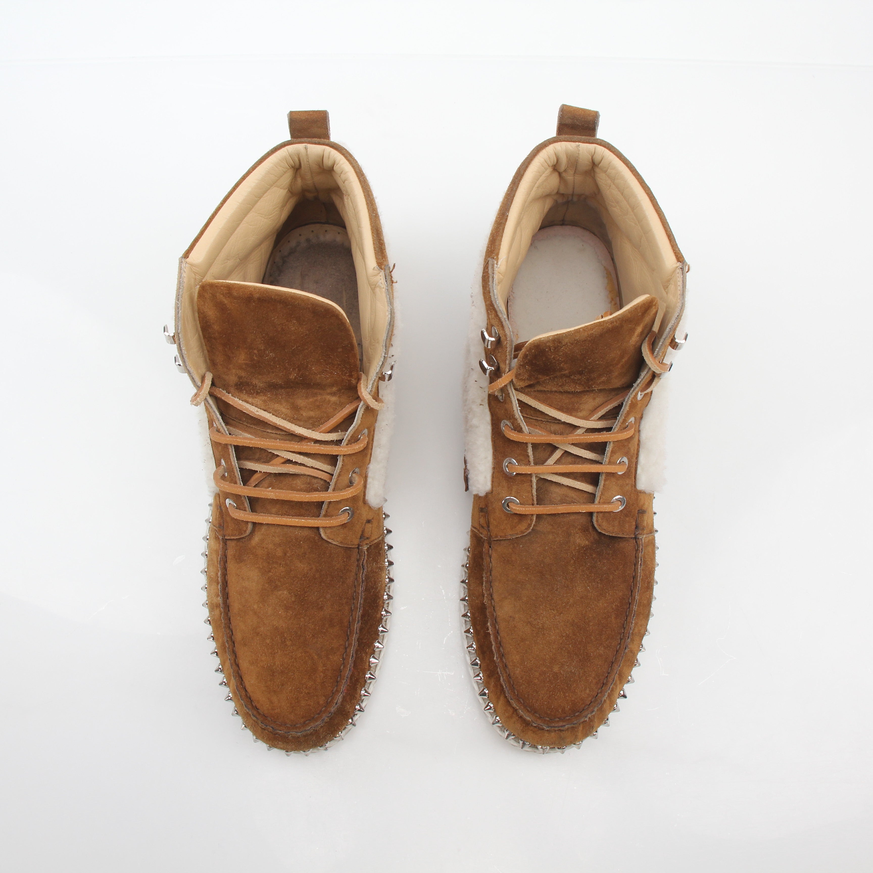 Christian Louboutin Steckel flat shearling boots in black with shearling lining and sleek leather exterior.