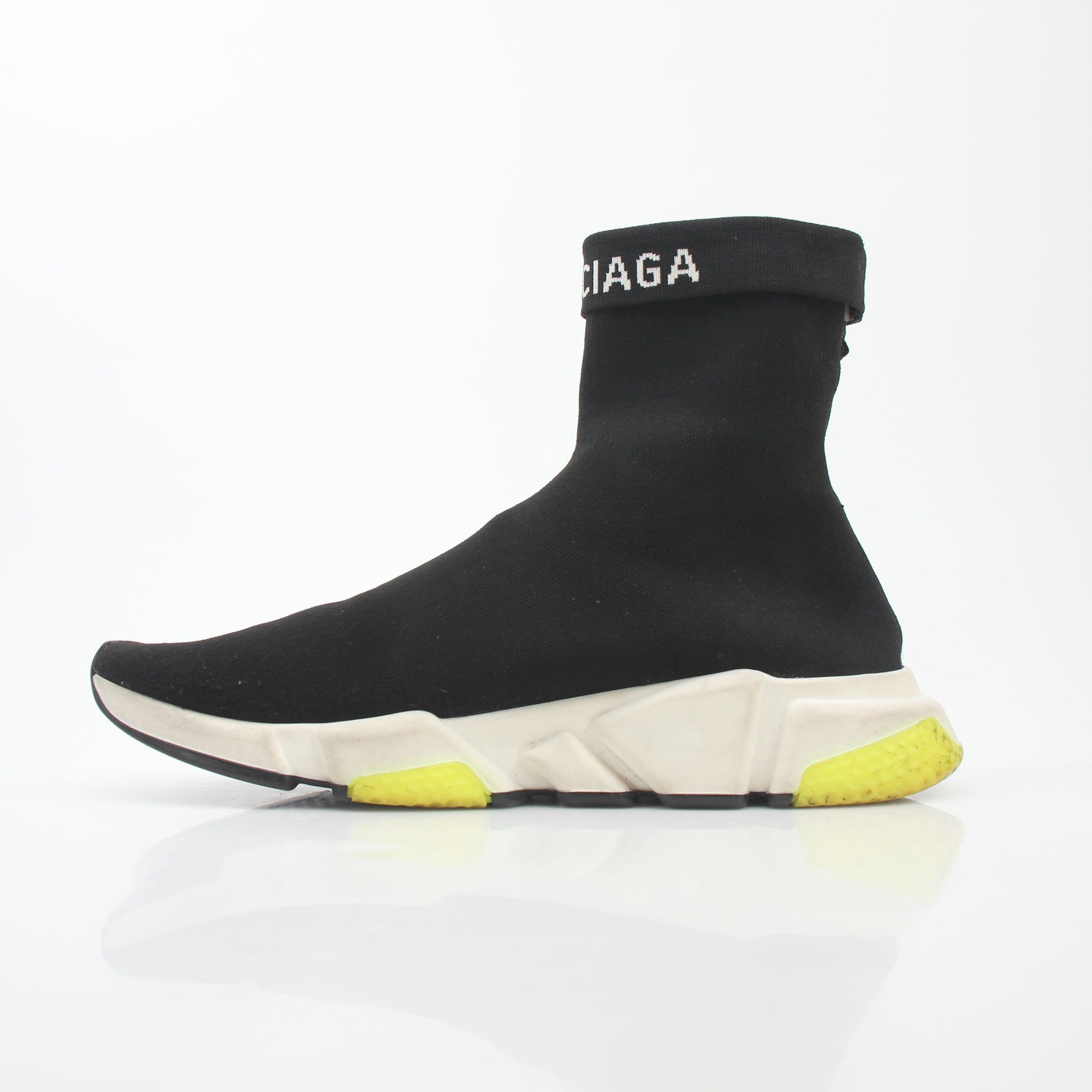 Black Balenciaga Speed 2.0 Turn Over Knit Sneakers with chunky soles and sleek design, worn by a model on a white background.