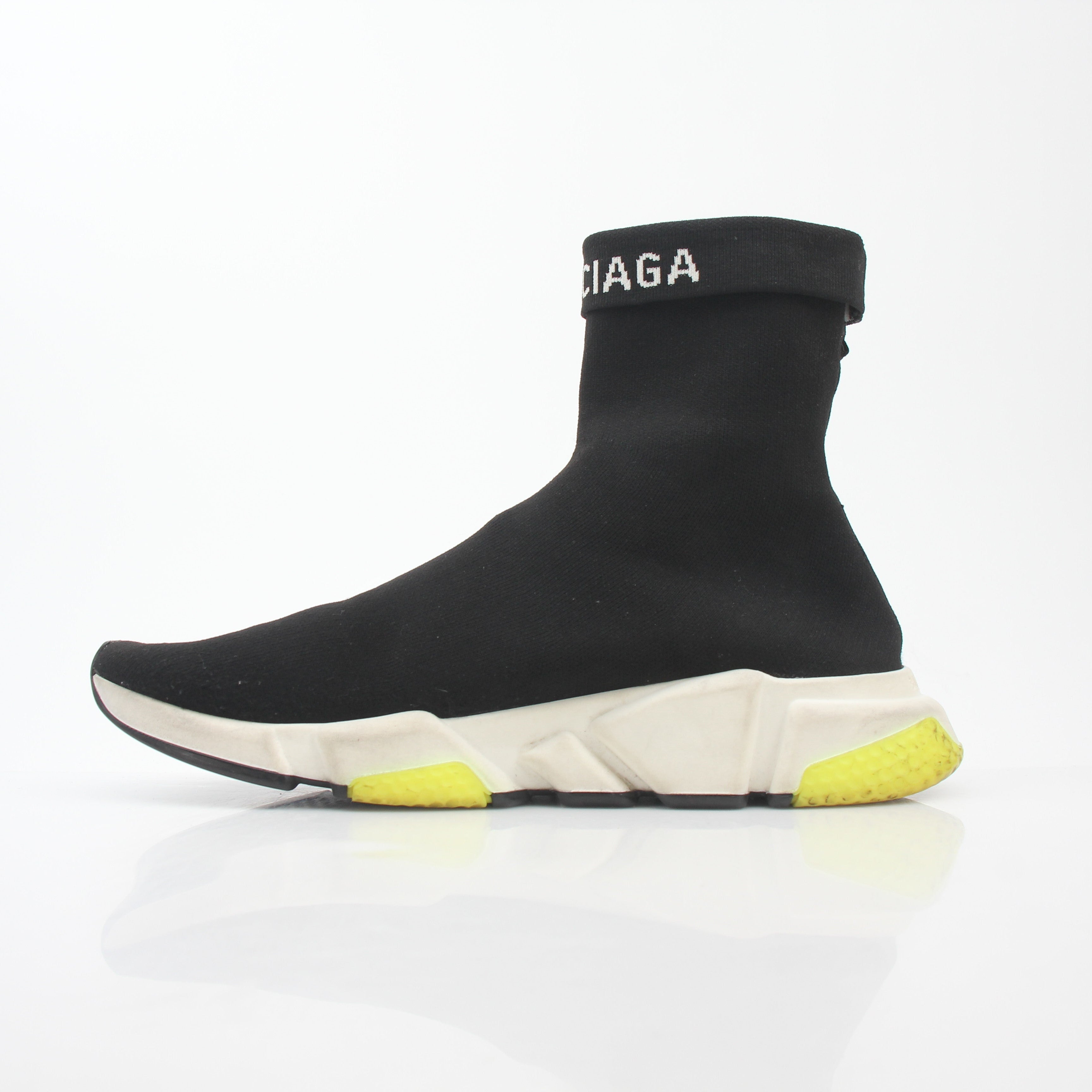 Black Balenciaga Speed 2.0 Turn Over Knit Sneakers with chunky soles and sleek design, worn by a model on a white background.