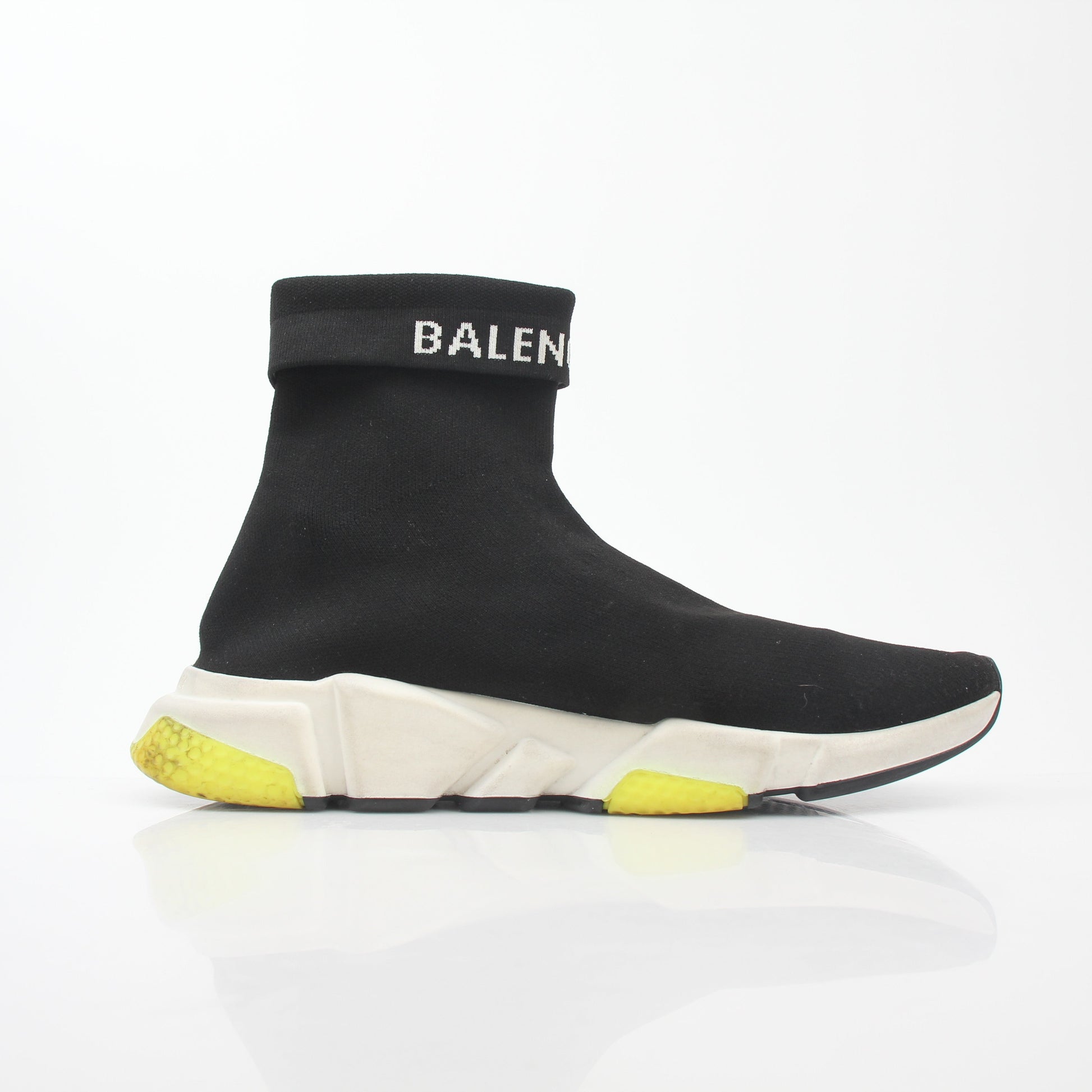 Black Balenciaga Speed 2.0 Turn Over Knit Sneakers with gold accents, showcasing sleek design and modern athletic style.