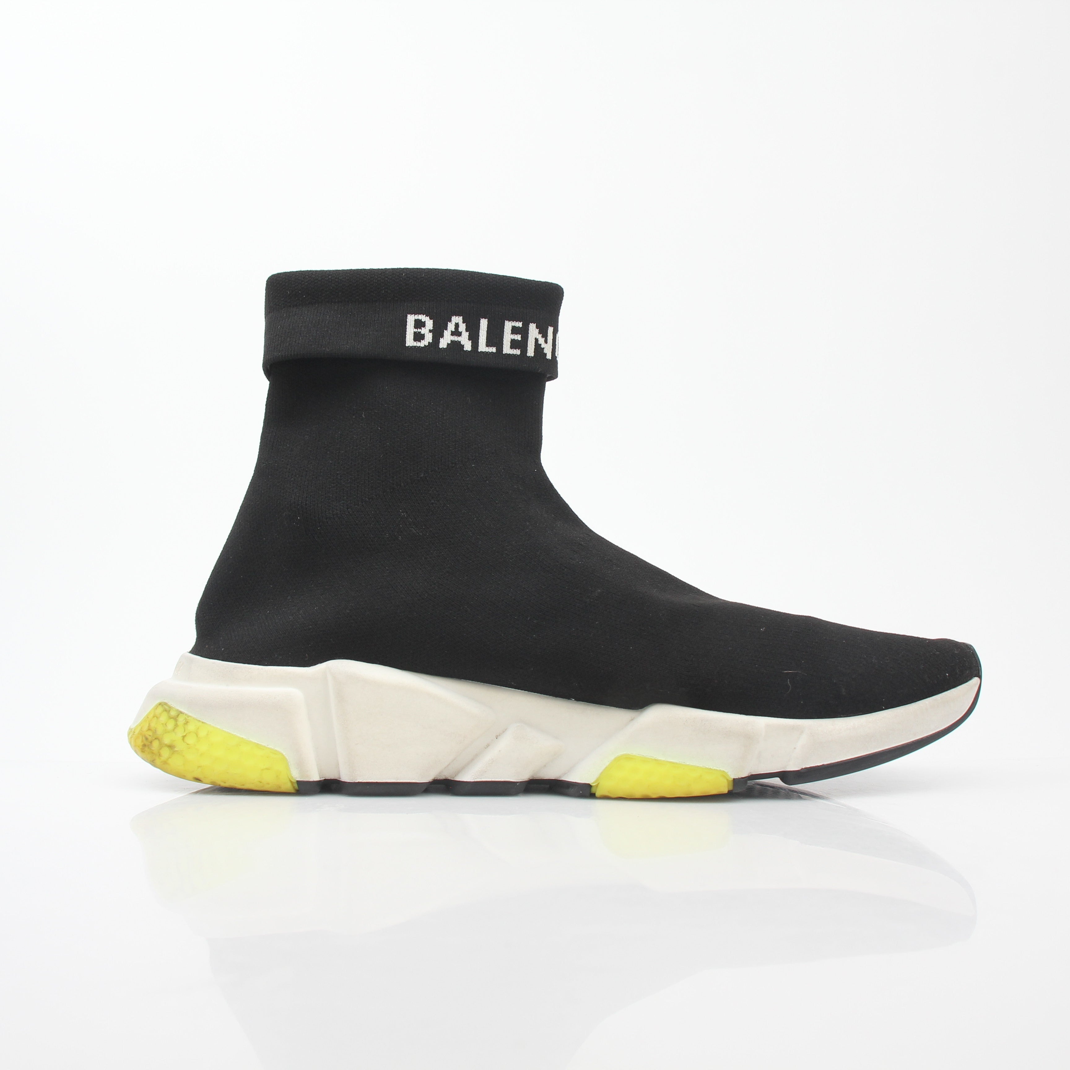 Black Balenciaga Speed 2.0 Turn Over Knit Sneakers with gold accents, showcasing sleek design and modern athletic style.