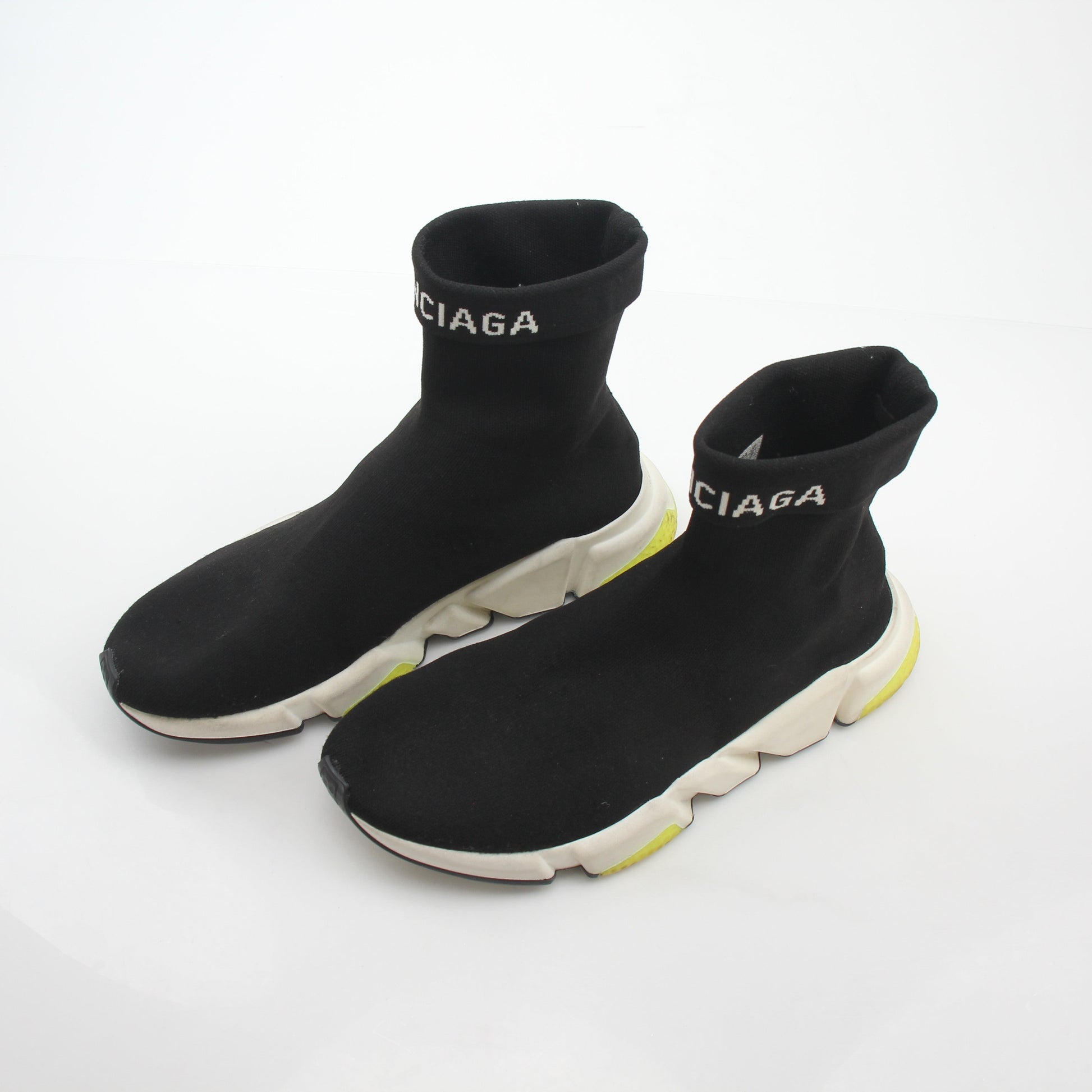 Black Balenciaga Speed 2.0 Turn Over Knit Sneakers with gold accents, showcasing the stylish design and sleek silhouette.