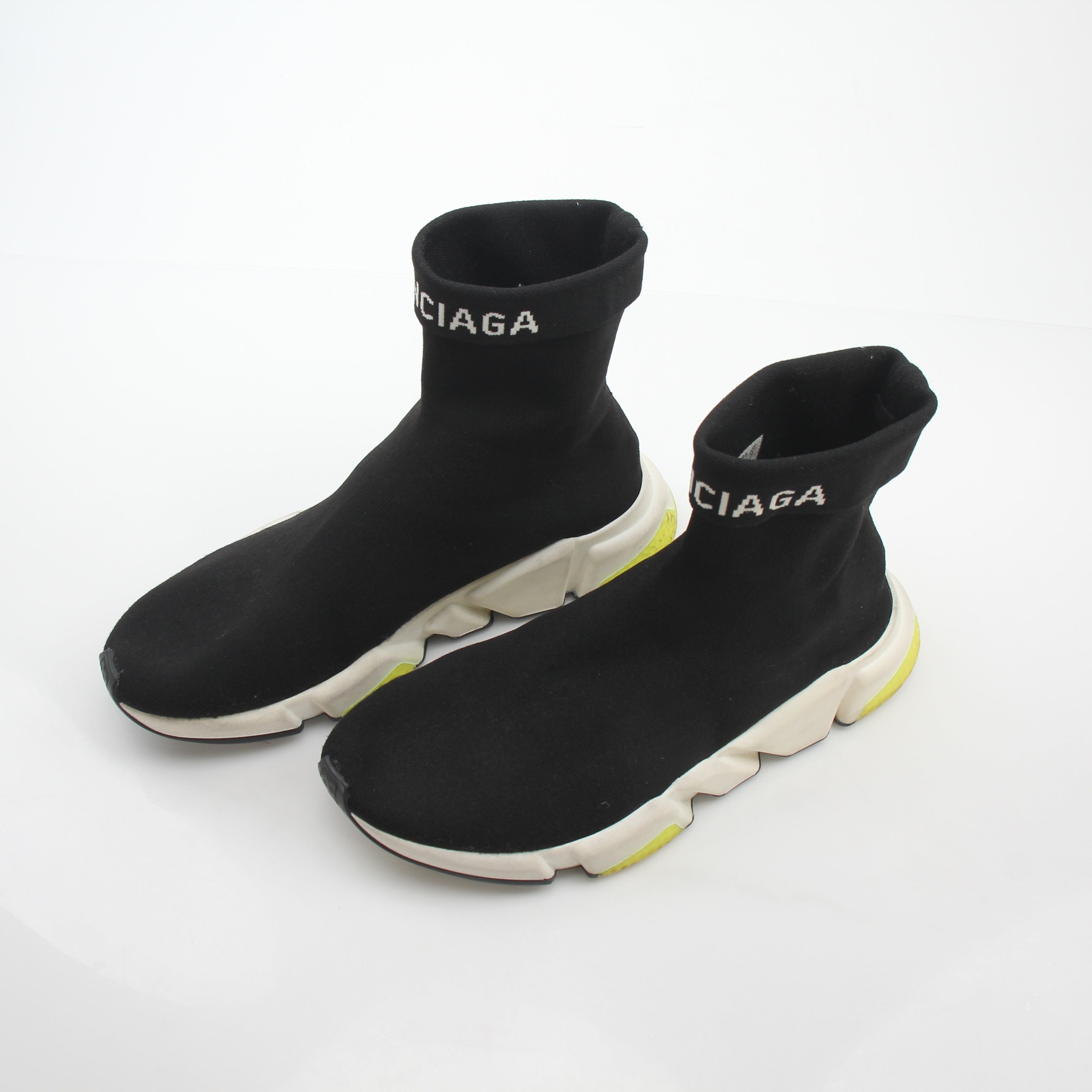 Black Balenciaga Speed 2.0 Turn Over Knit Sneakers with gold accents, showcasing the stylish design and sleek silhouette.