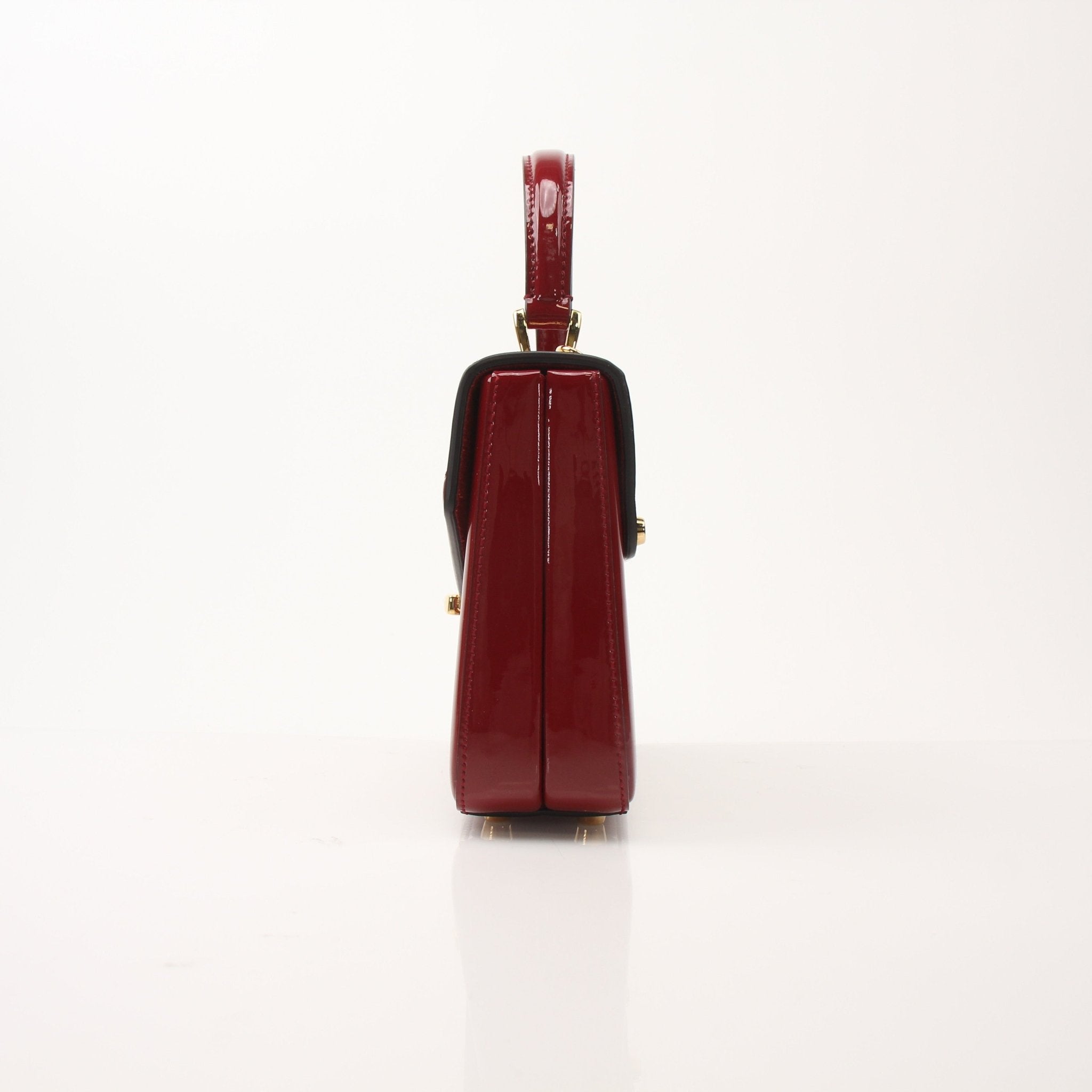 Gucci Sylvie 1969 Mini Top Handle Bag in leather with signature hardware, featuring a structured design and top handle.