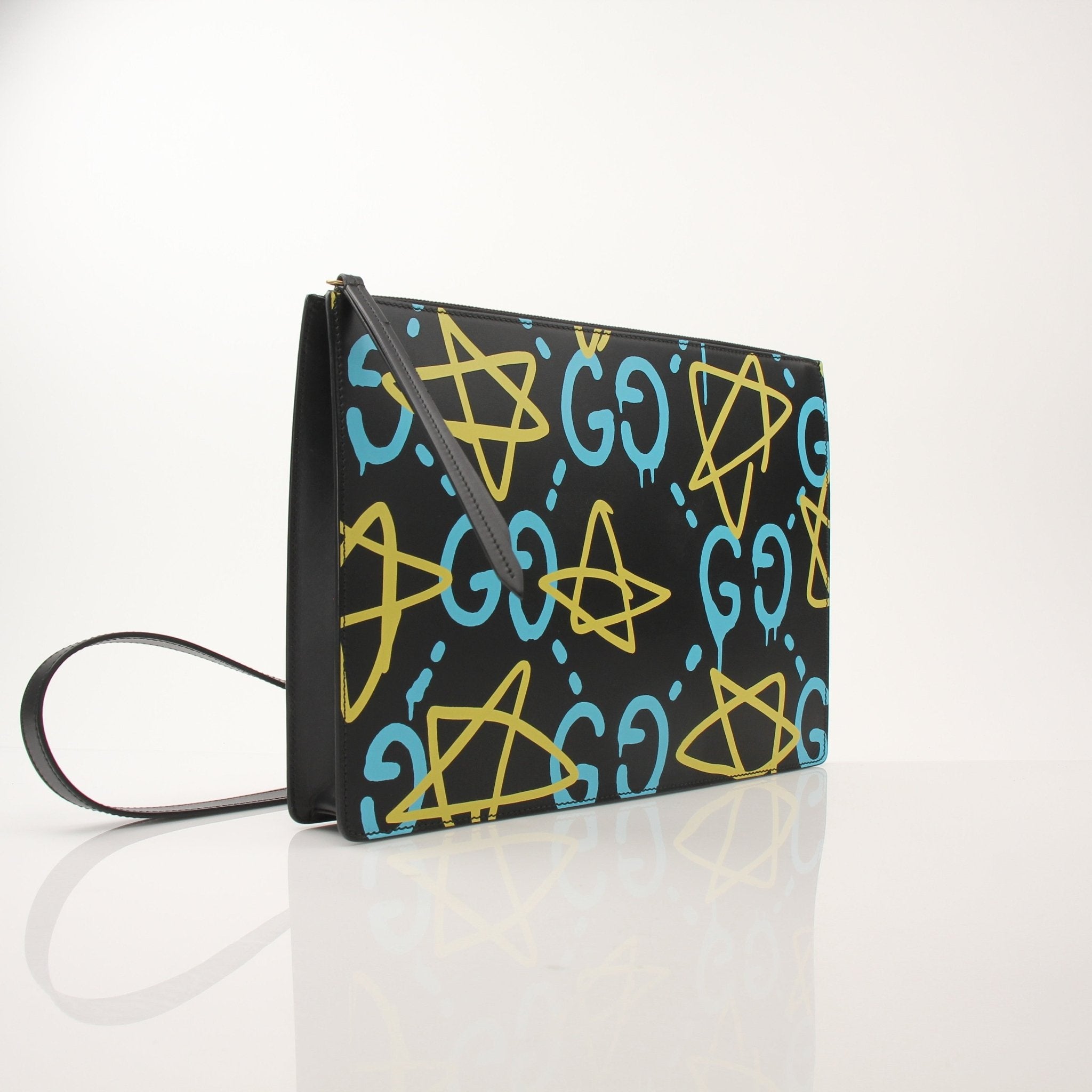 Gucci Ghost Messenger Bag handbag with black leather, gold hardware, and Gucci logo details, carried as a stylish accessory.