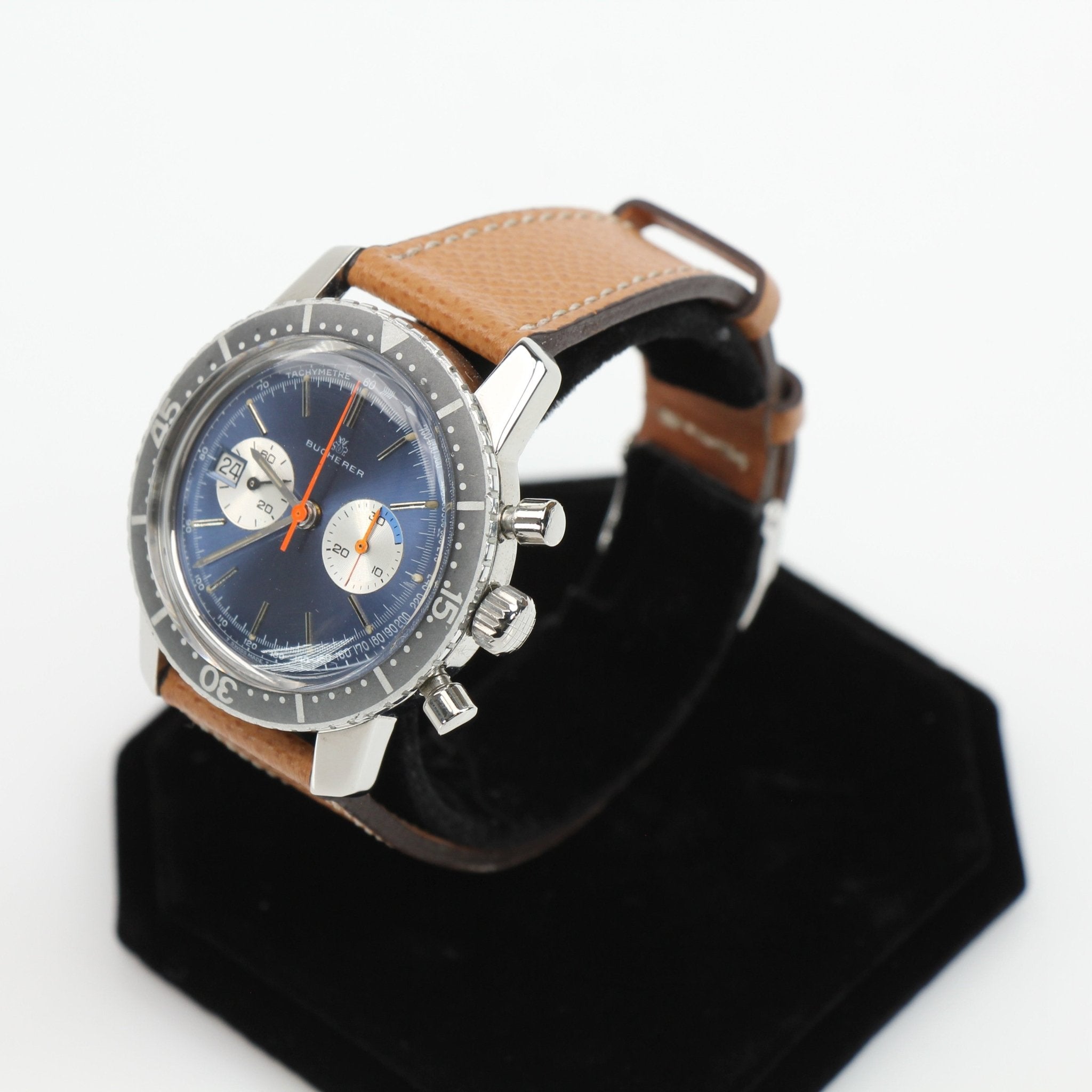 Gold & Beyond Bucherer Vintage Chronograph watch with black dial and stainless steel band on a white background.