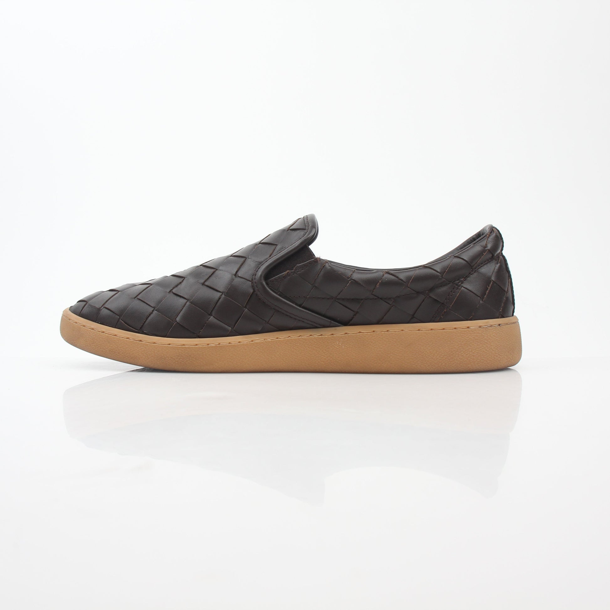 Brown Bottega Veneta Sawyer Intrecciato slip-on sneakers with woven leather design, displayed on a clean surface.