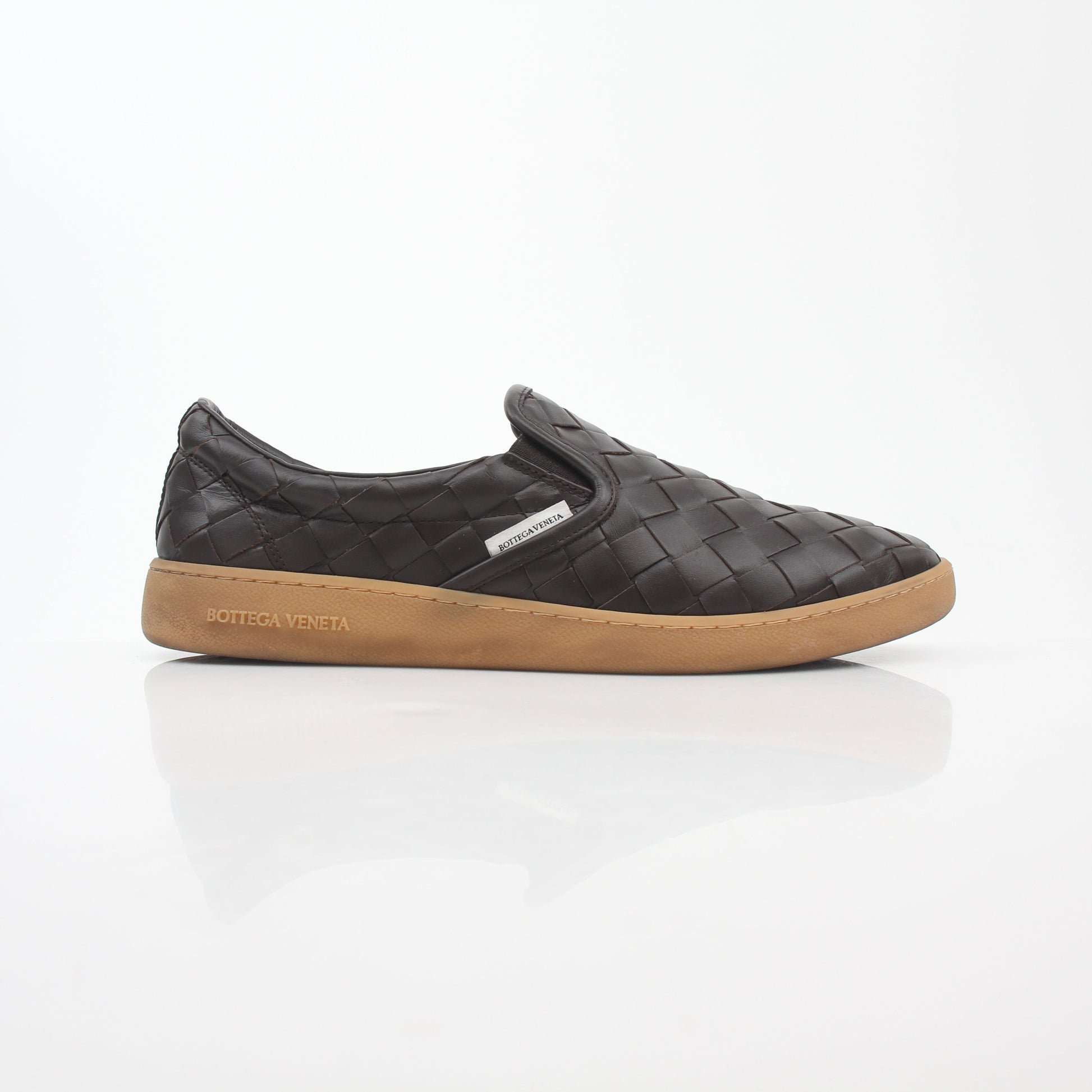 Brown Bottega Veneta Sawyer Intrecciato slip-on sneakers with woven leather design, displayed on a white background.