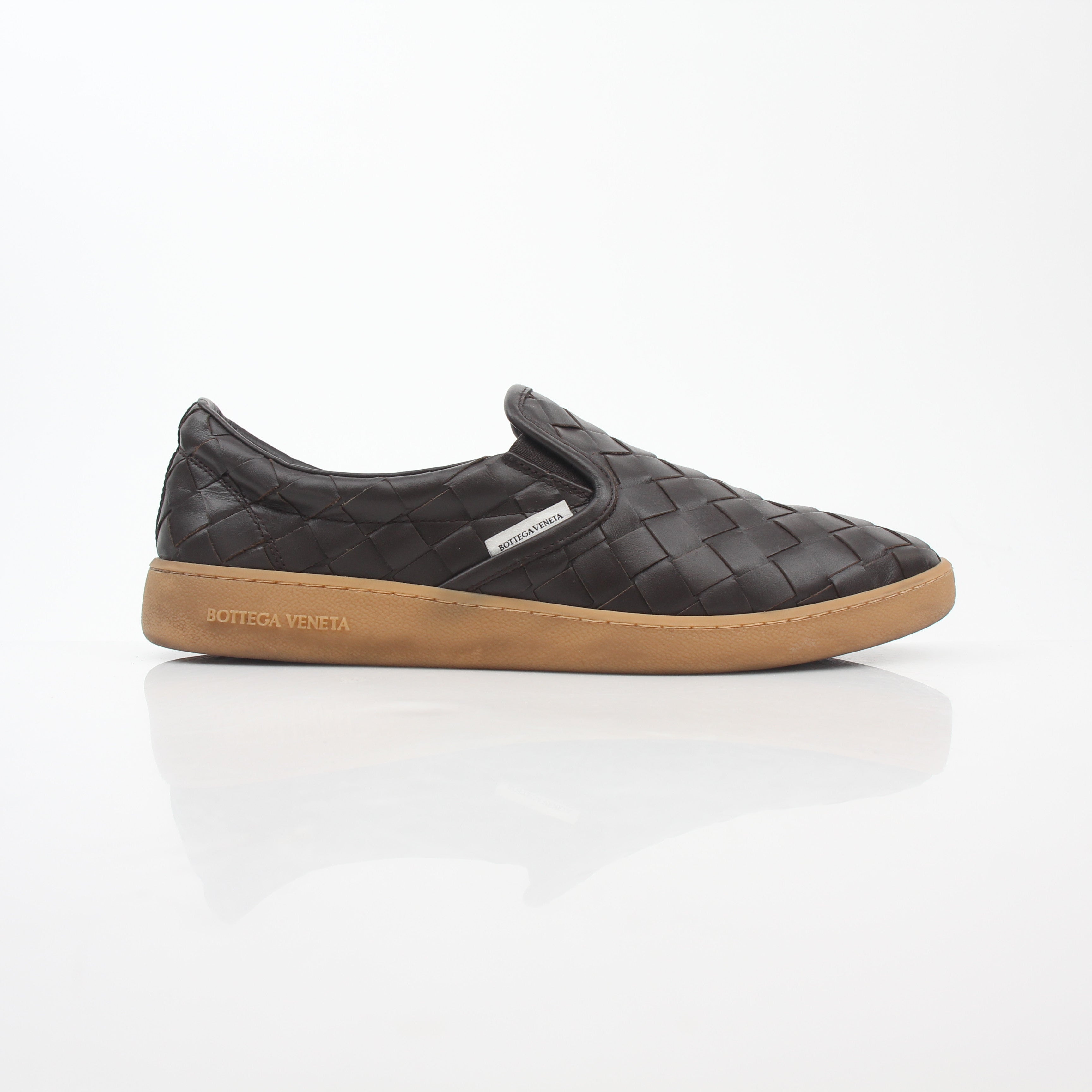 Brown Bottega Veneta Sawyer Intrecciato slip-on sneakers with woven leather design, displayed on a white background.