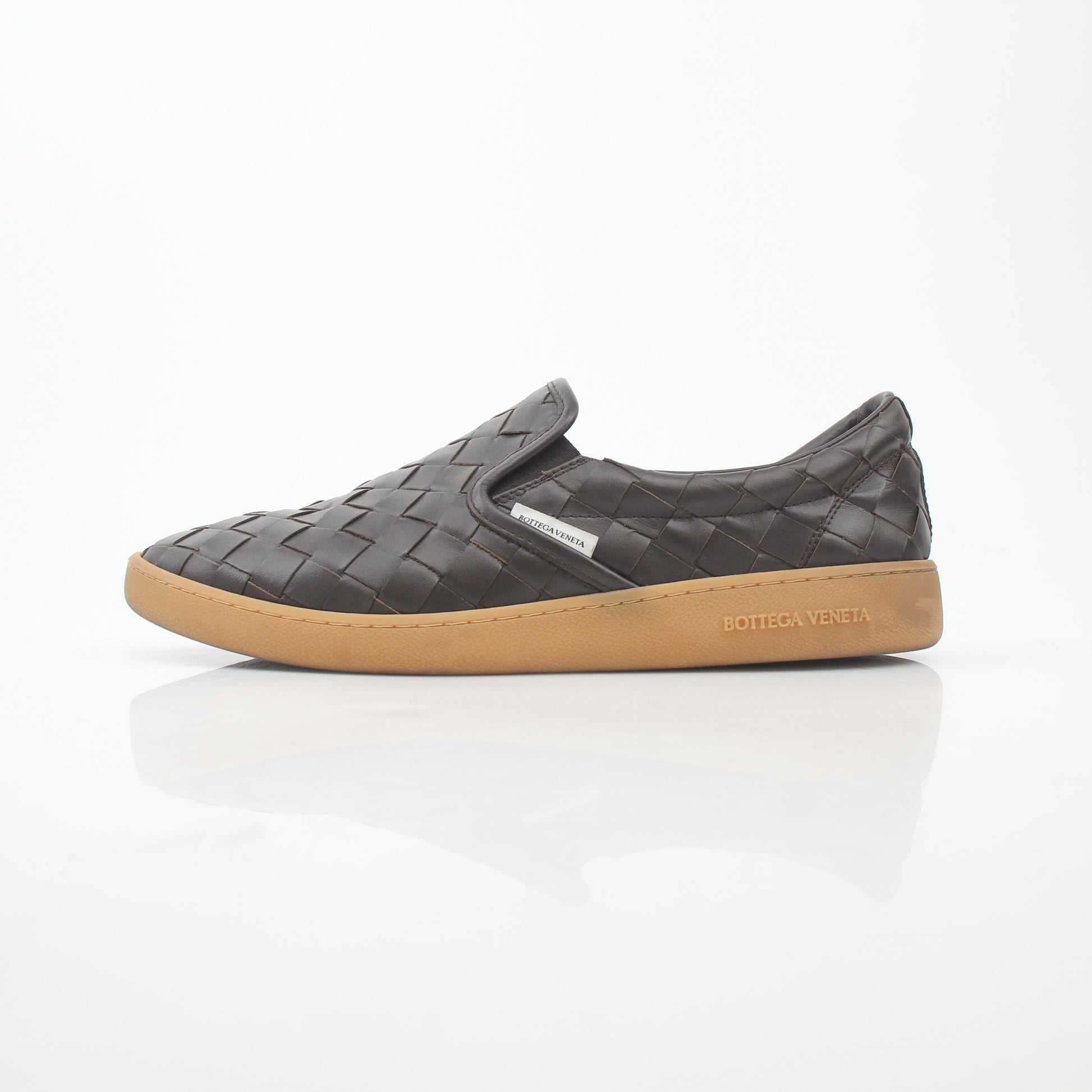 Brown Bottega Veneta Sawyer Intrecciato slip-on sneakers with woven leather design, displayed on a white background