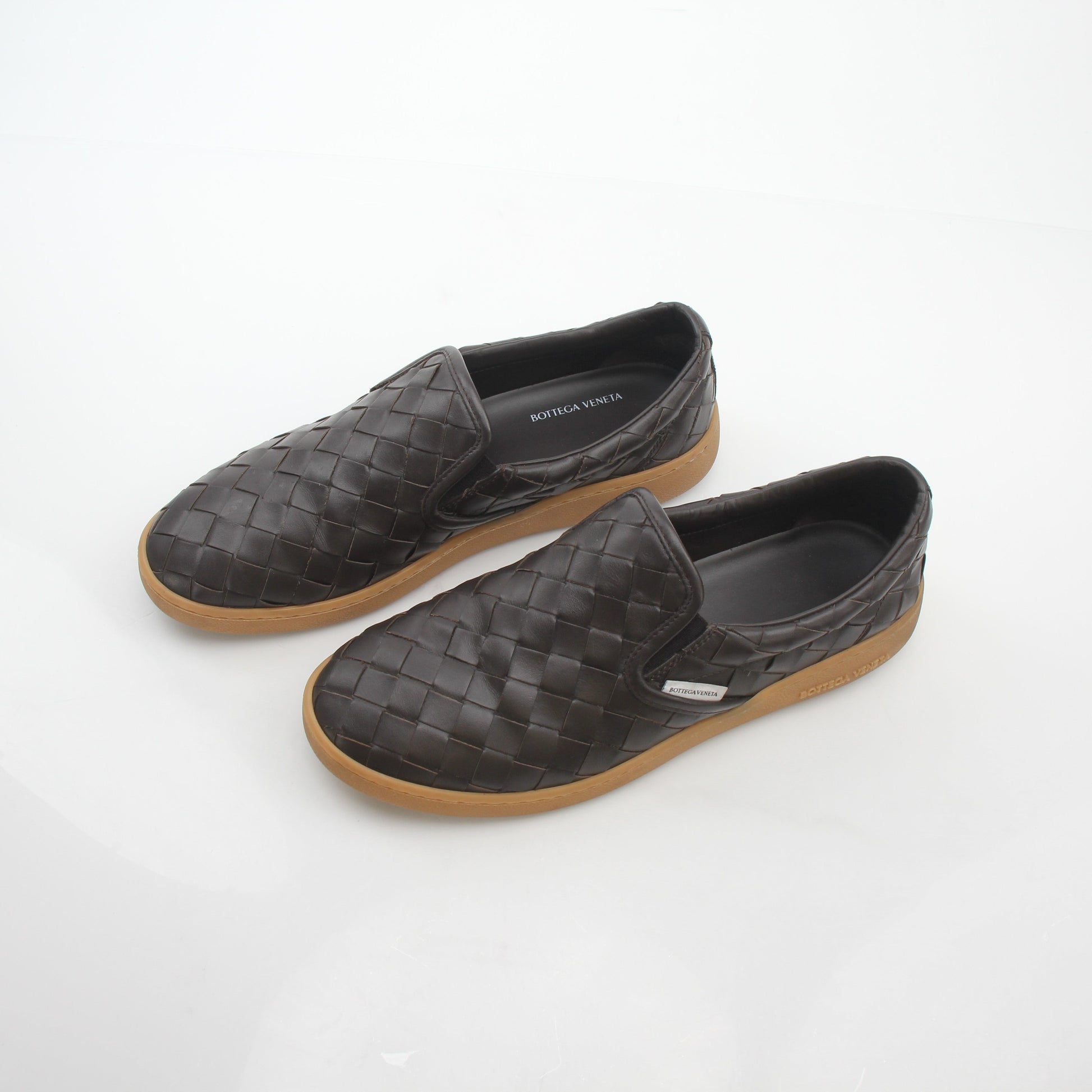 Brown Bottega Veneta Sawyer Intrecciato slip-on sneakers with woven leather design, shown on a clean white background.