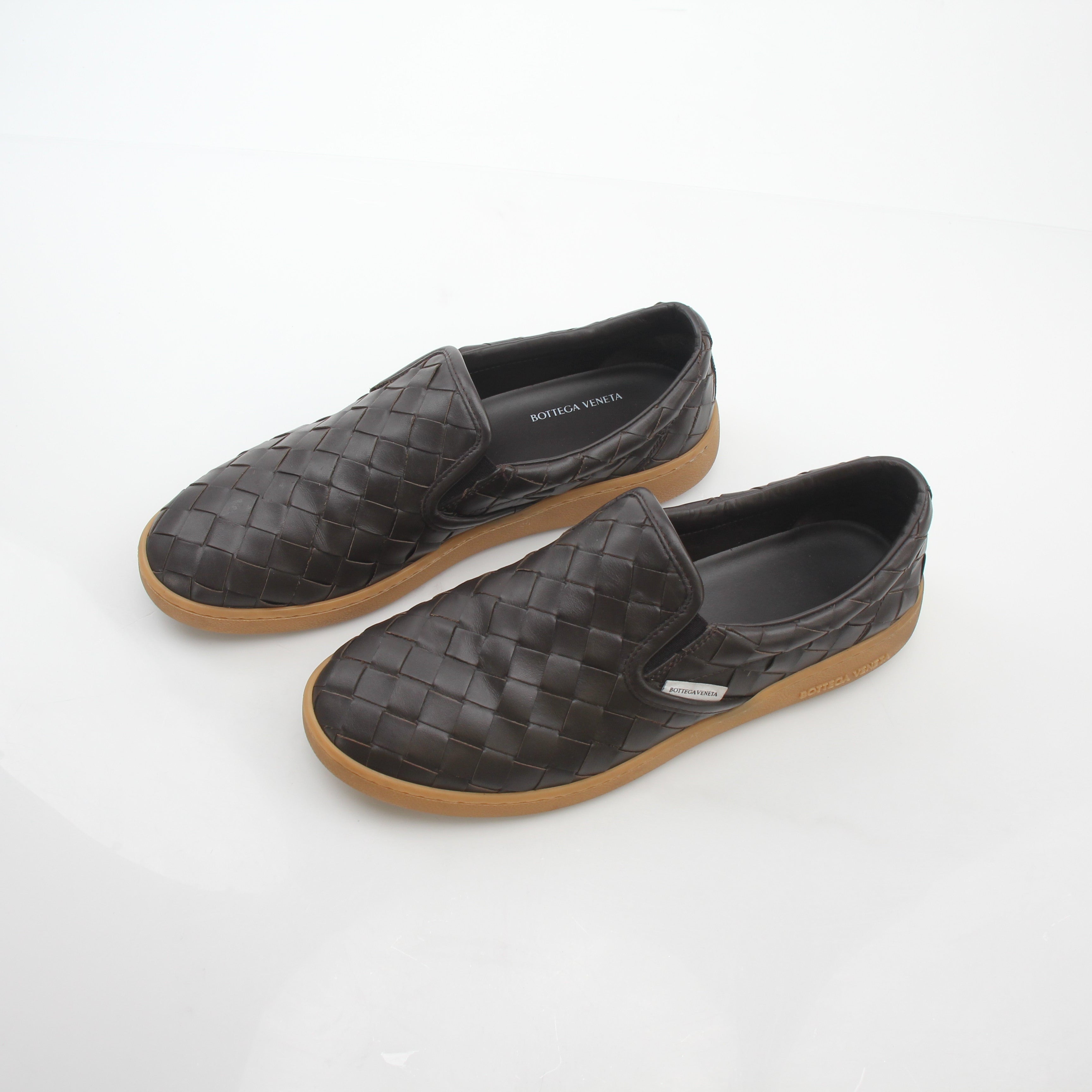 Brown Bottega Veneta Sawyer Intrecciato slip-on sneakers with woven leather design, shown on a clean white background.
