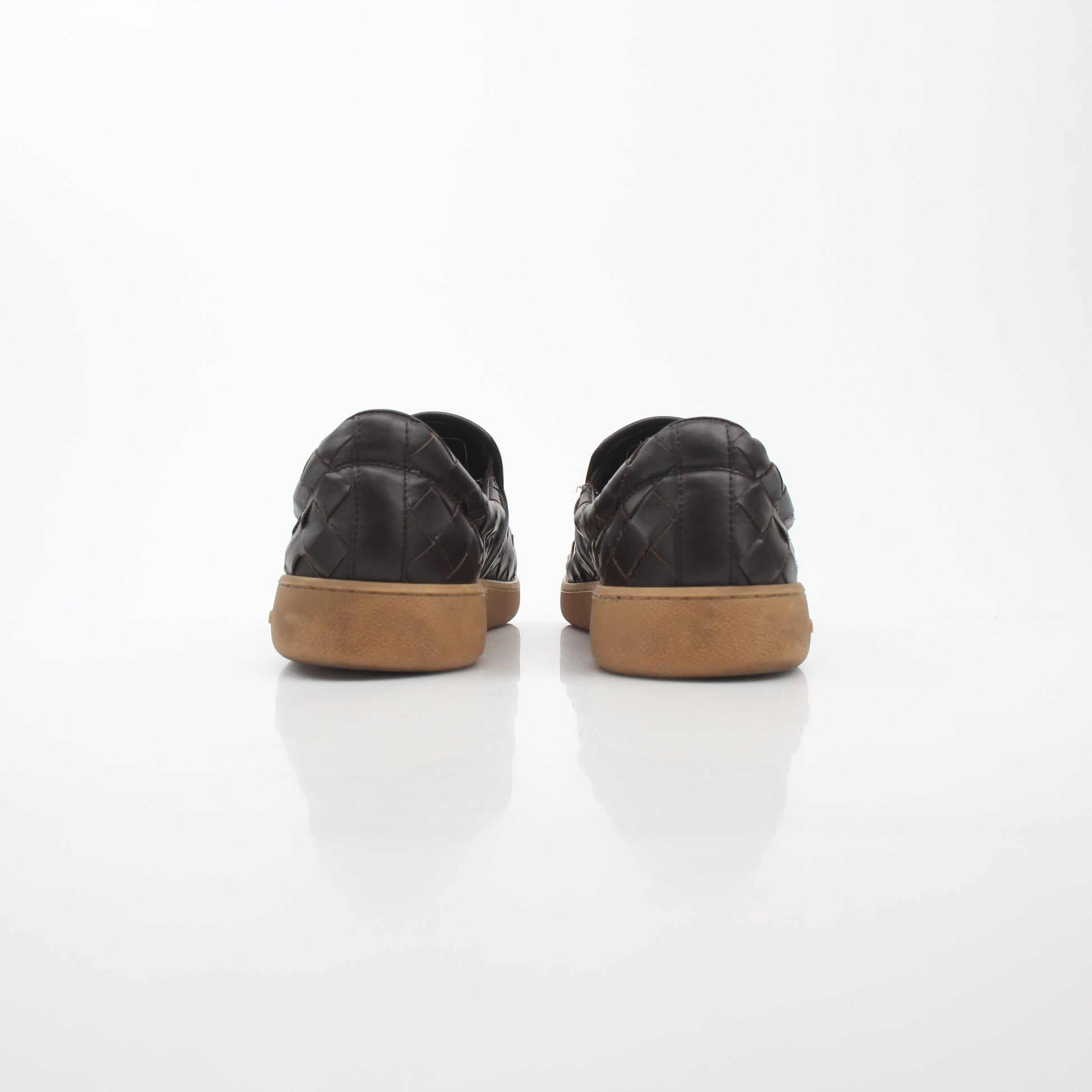 Brown Bottega Veneta Sawyer Intrecciato slip-on sneakers, stylish shoes with woven leather design, set on a plain background.