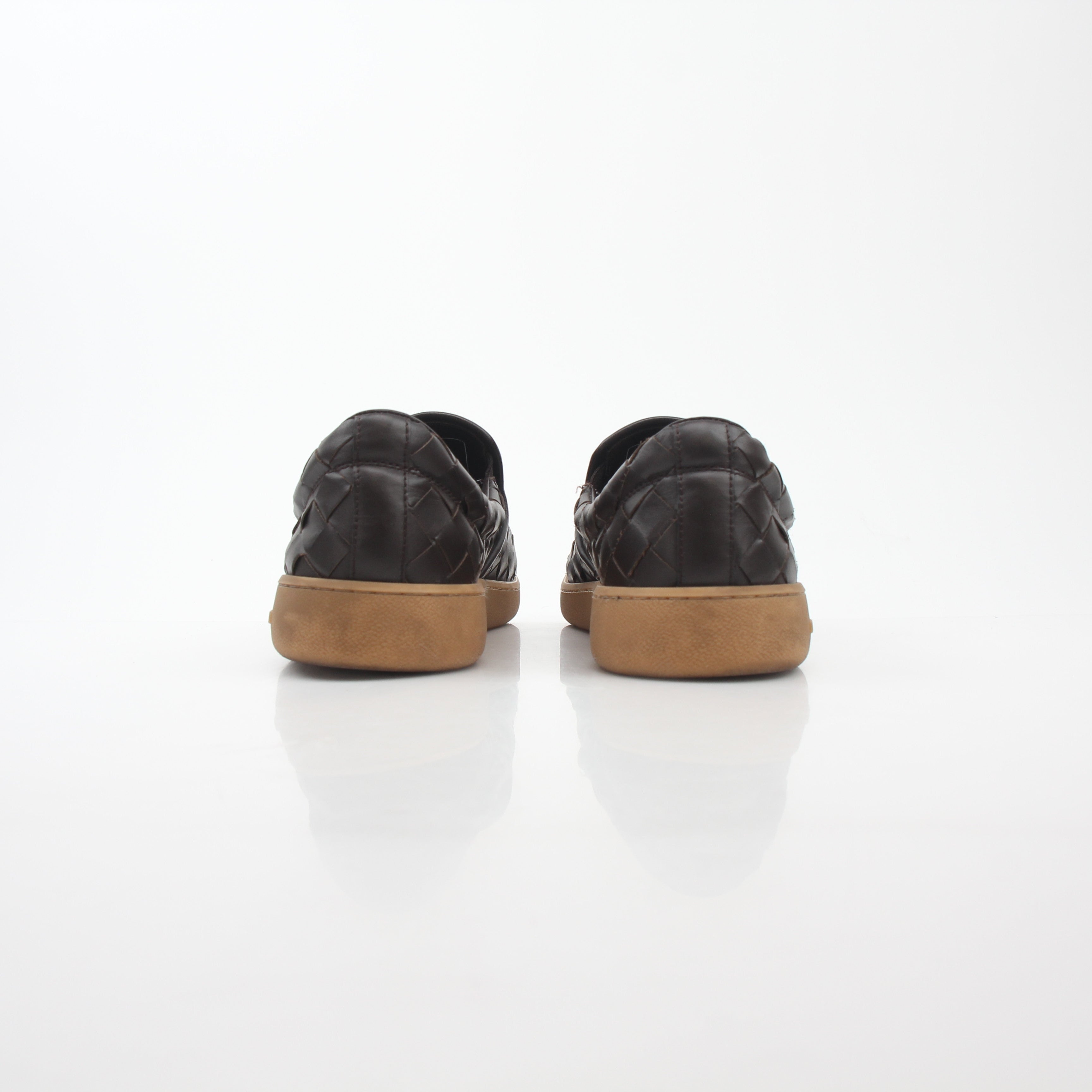 Brown Bottega Veneta Sawyer Intrecciato slip-on sneakers, stylish shoes with woven leather design, set on a plain background.