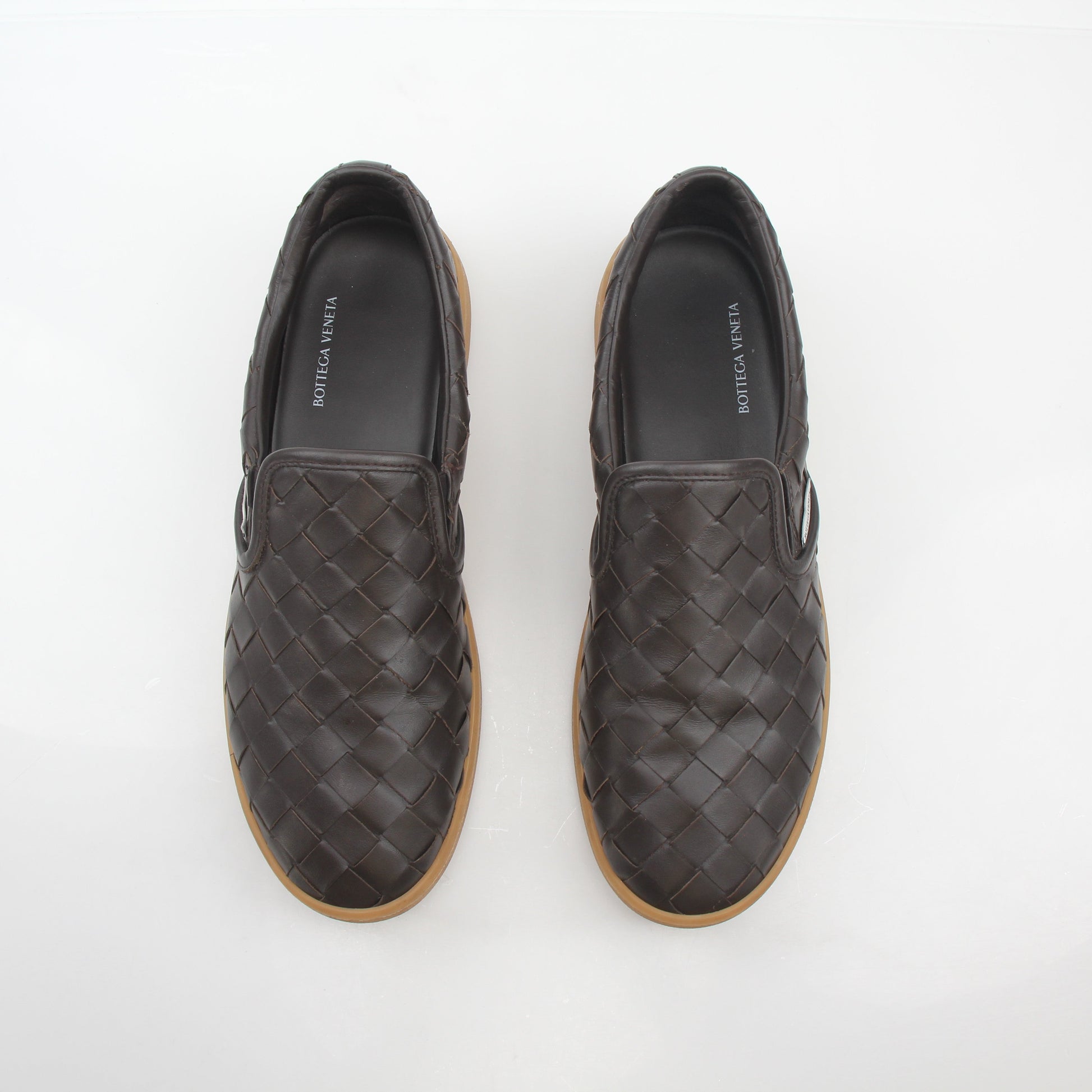 Brown Bottega Veneta Sawyer Intrecciato slip-on sneakers with woven leather design, shown on a plain background.