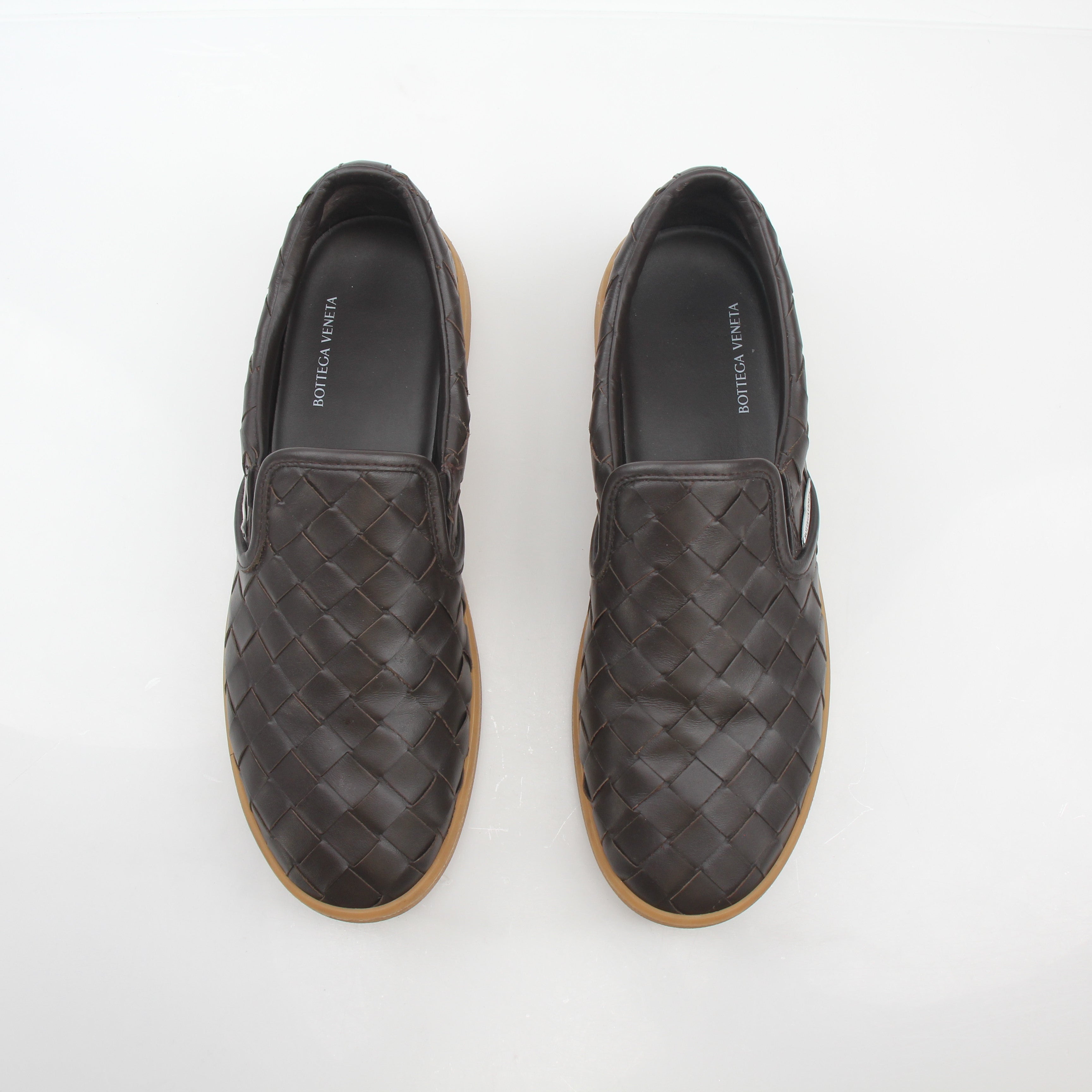 Brown Bottega Veneta Sawyer Intrecciato slip-on sneakers with woven leather design, shown on a plain background.