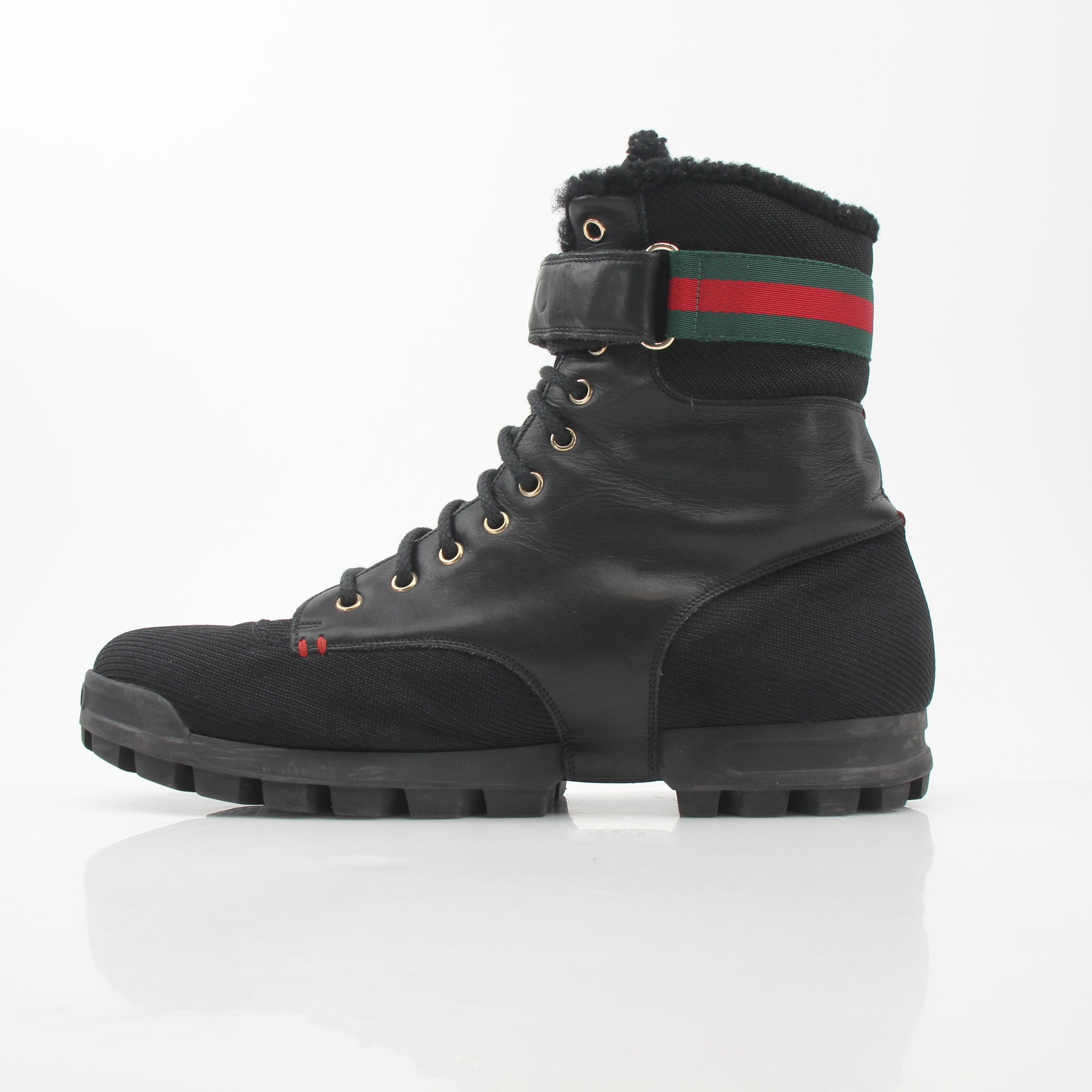 Gucci black Web accent combat boots, gold and beyond shoes with rugged style and sturdy design, visible laces and textured sole.
