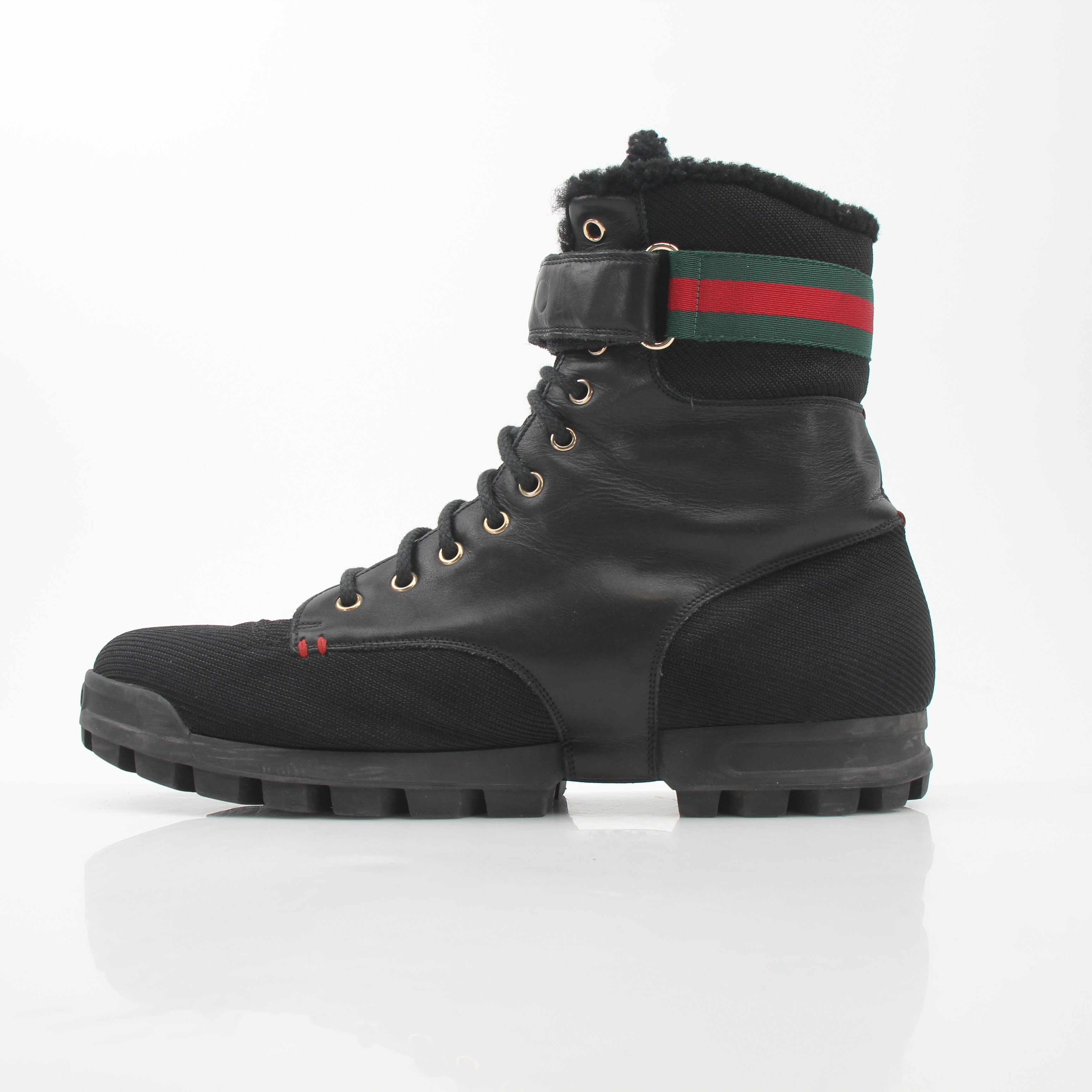 Gucci black Web accent combat boots, gold and beyond shoes with rugged style and sturdy design, visible laces and textured sole.