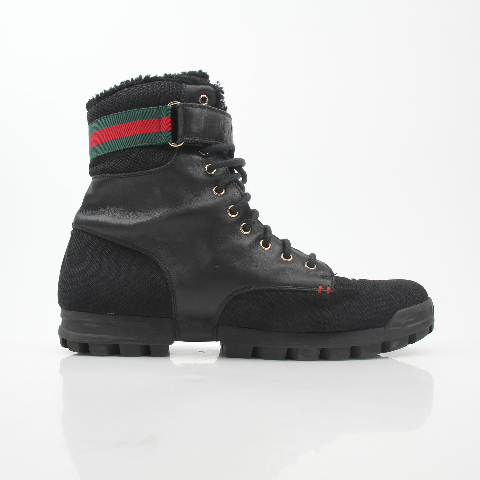 Gucci black web accent combat shoes with lace-up design and sturdy sole, showcasing stylish footwear by Gold & Beyond.