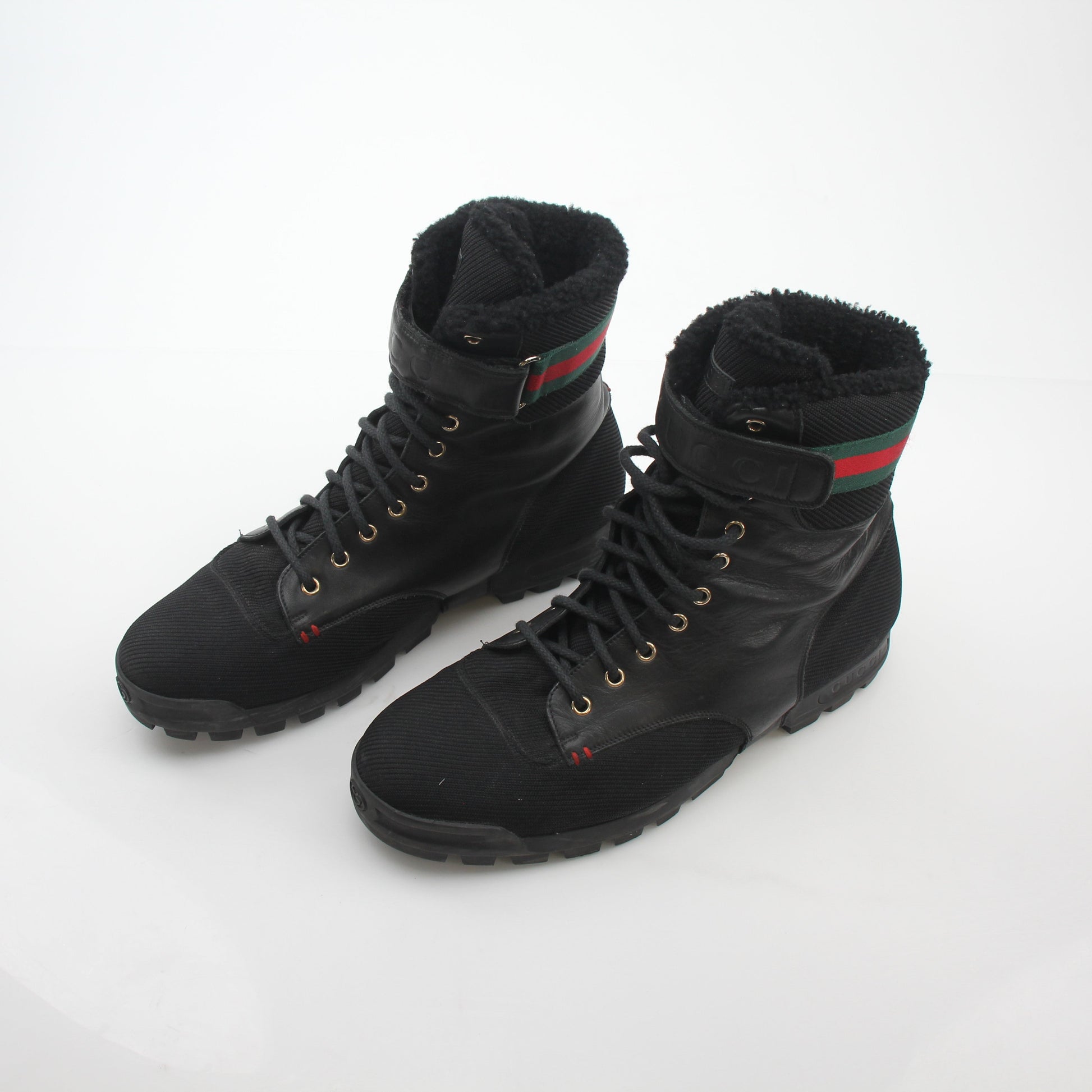 Gucci black Web accent combat boots featuring sturdy leather and signature design elements, stylish and durable shoes.