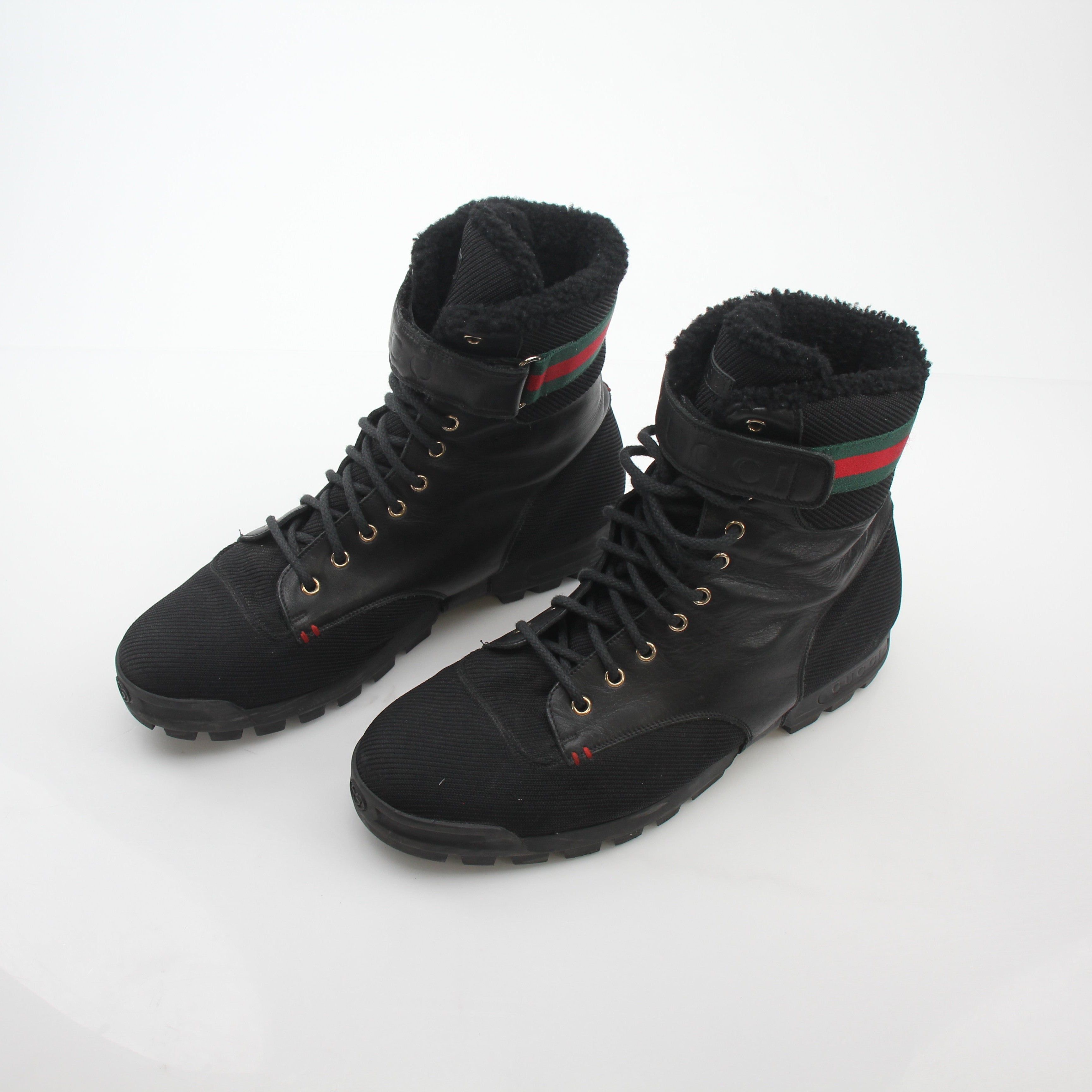 Gucci black Web accent combat boots featuring sturdy leather and signature design elements, stylish and durable shoes.