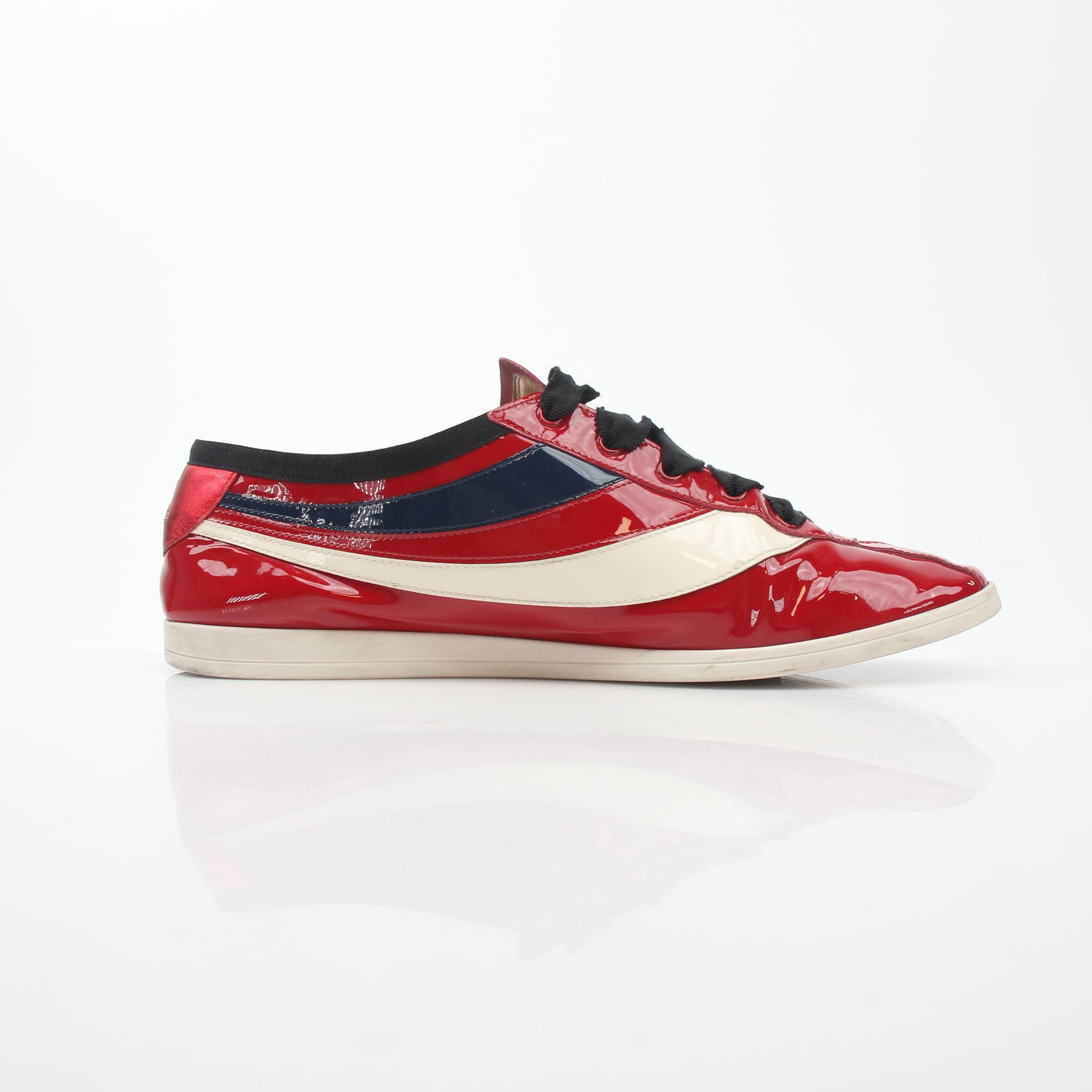 Red Gucci Falacer Hebron Web sneakers with gold accents, stylish shoes featuring a sporty design and iconic branding.