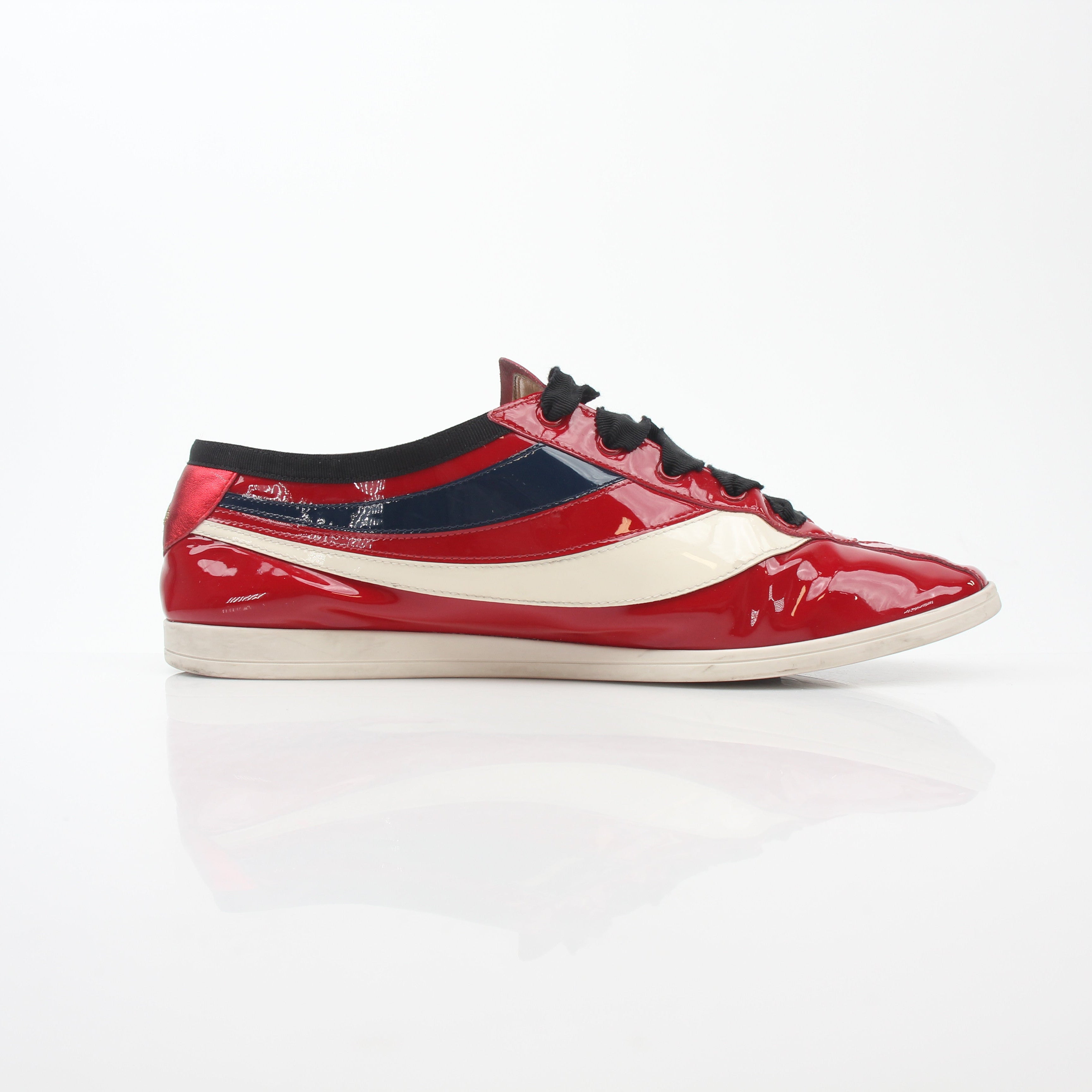Red Gucci Falacer Hebron Web sneakers with gold accents, stylish shoes featuring a sporty design and iconic branding.