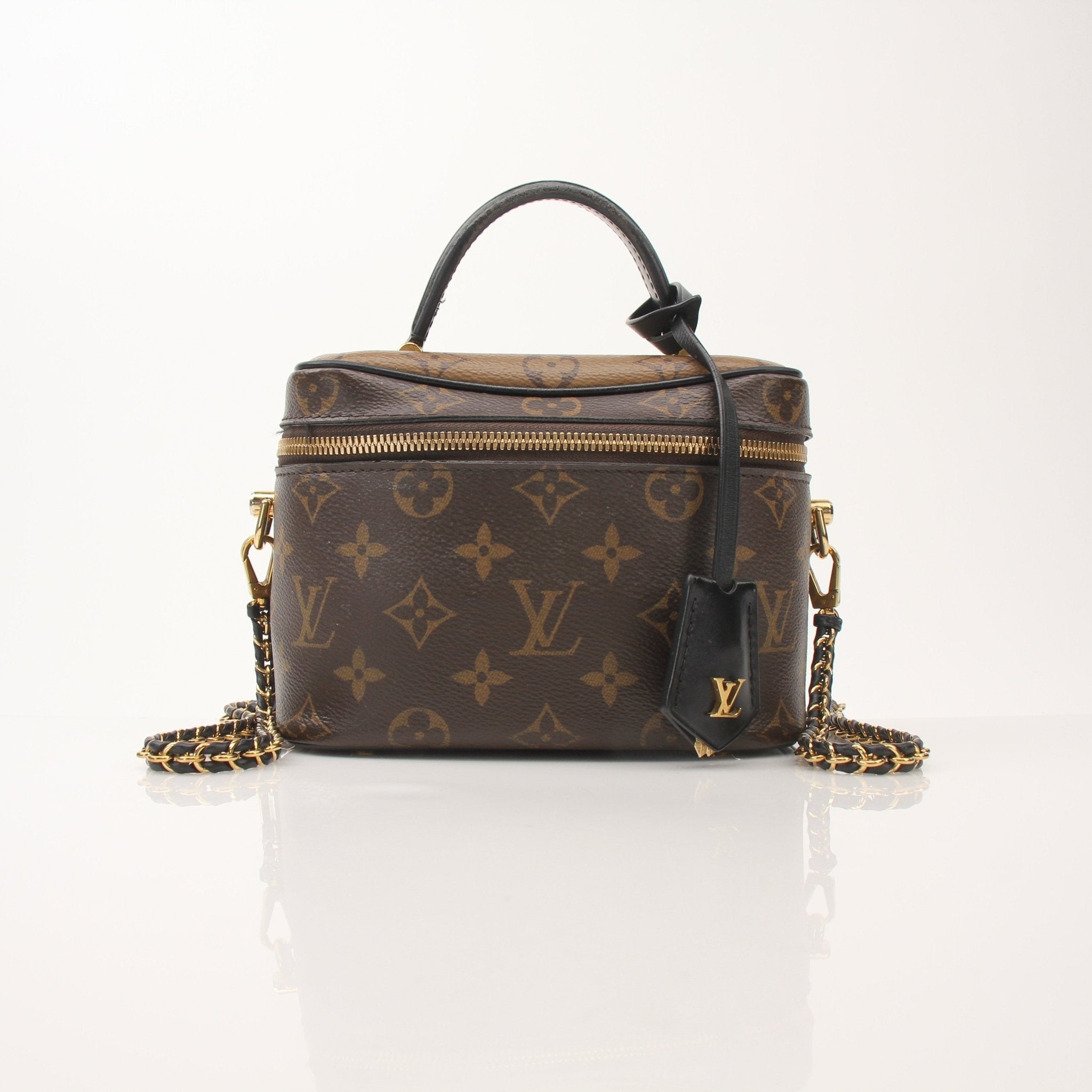 Louis Vuitton Vanity PM top handle crossbody handbag with gold accents and structured design, shown in the product image.