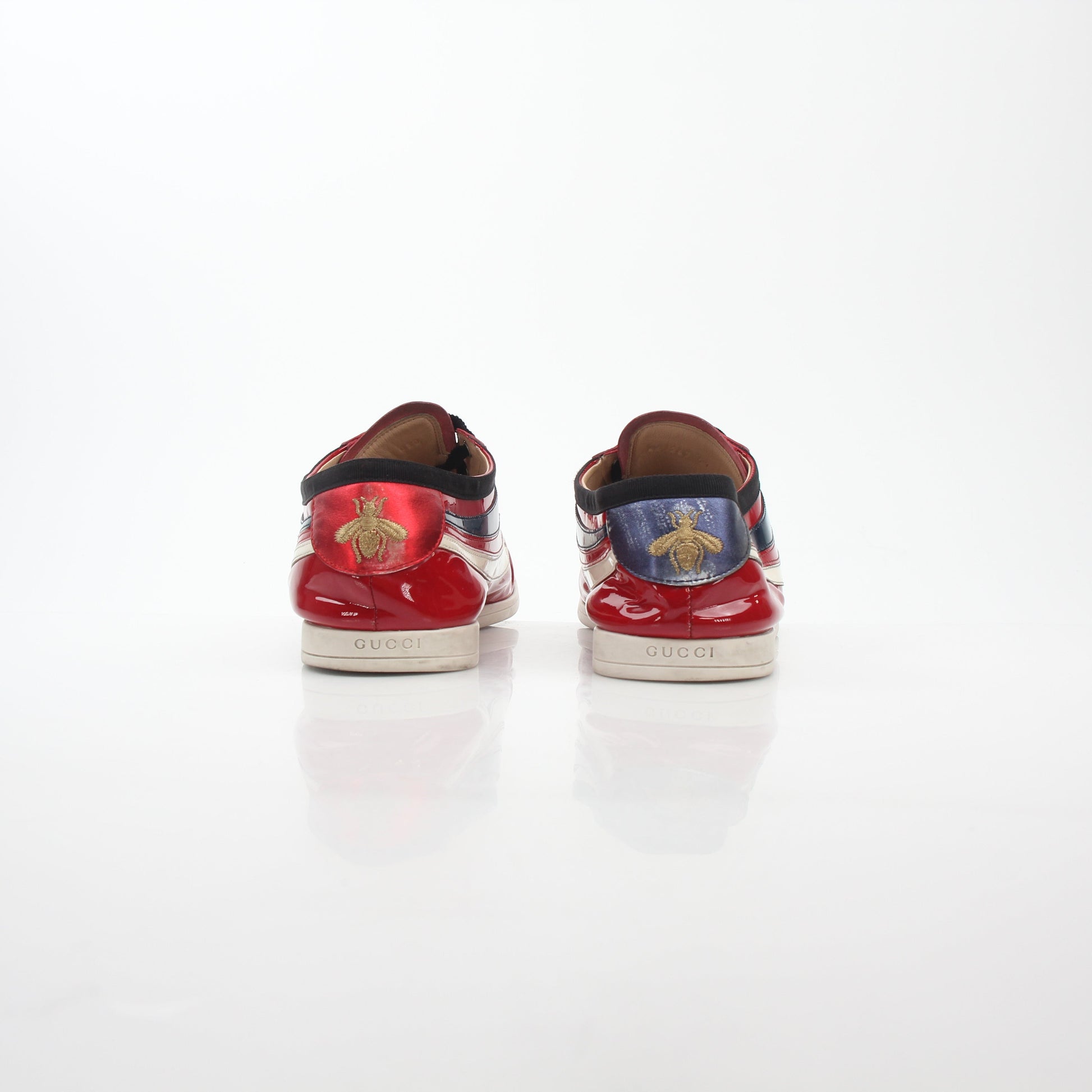 Gucci Red Falacer Hebron Web sneakers in shoes, featuring red fabric and web detailing, displayed on a white background.