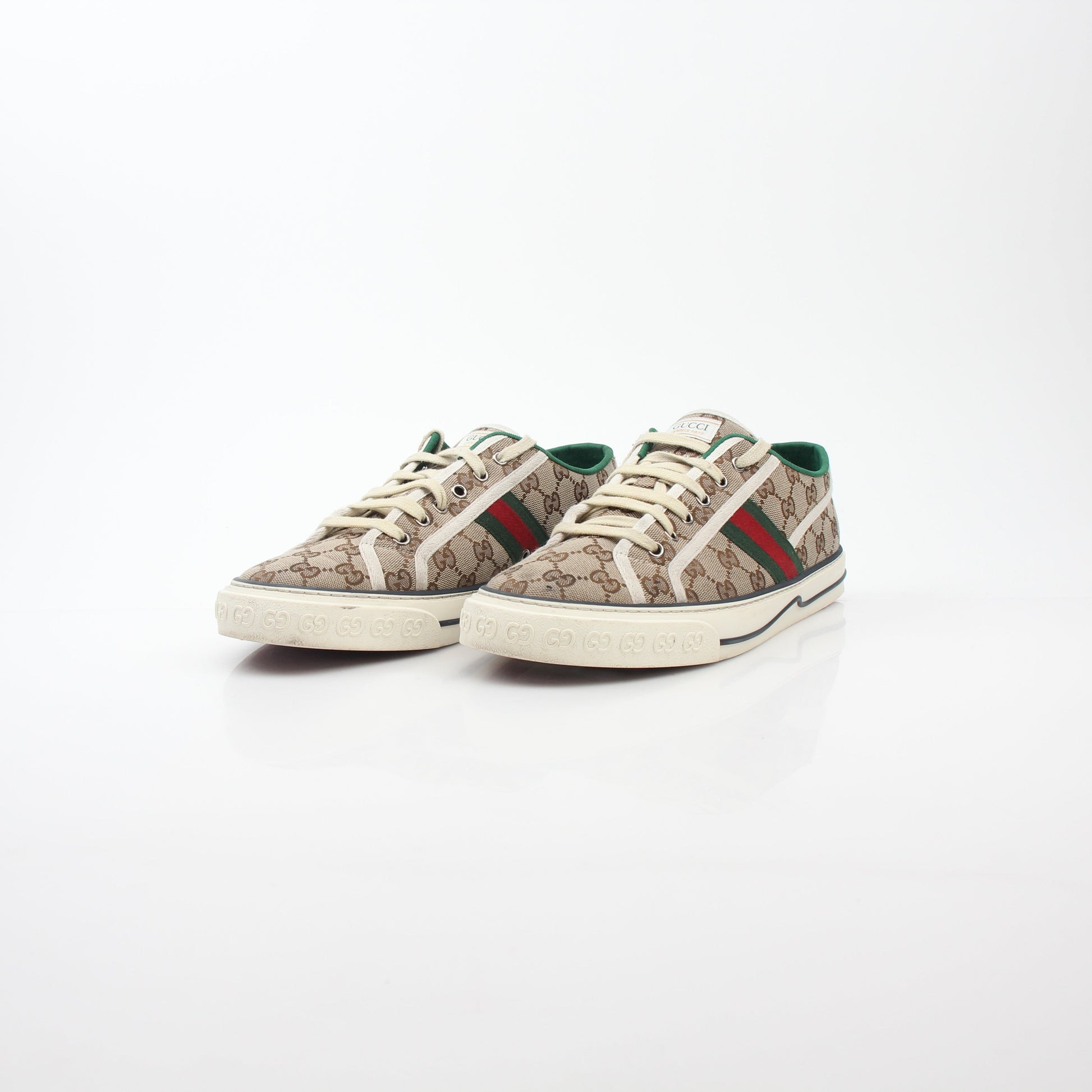 Gold & Beyond Gucci Beige GG Tennis 1977 sneakers, showing classic design with beige canvas and rubber sole detail.
