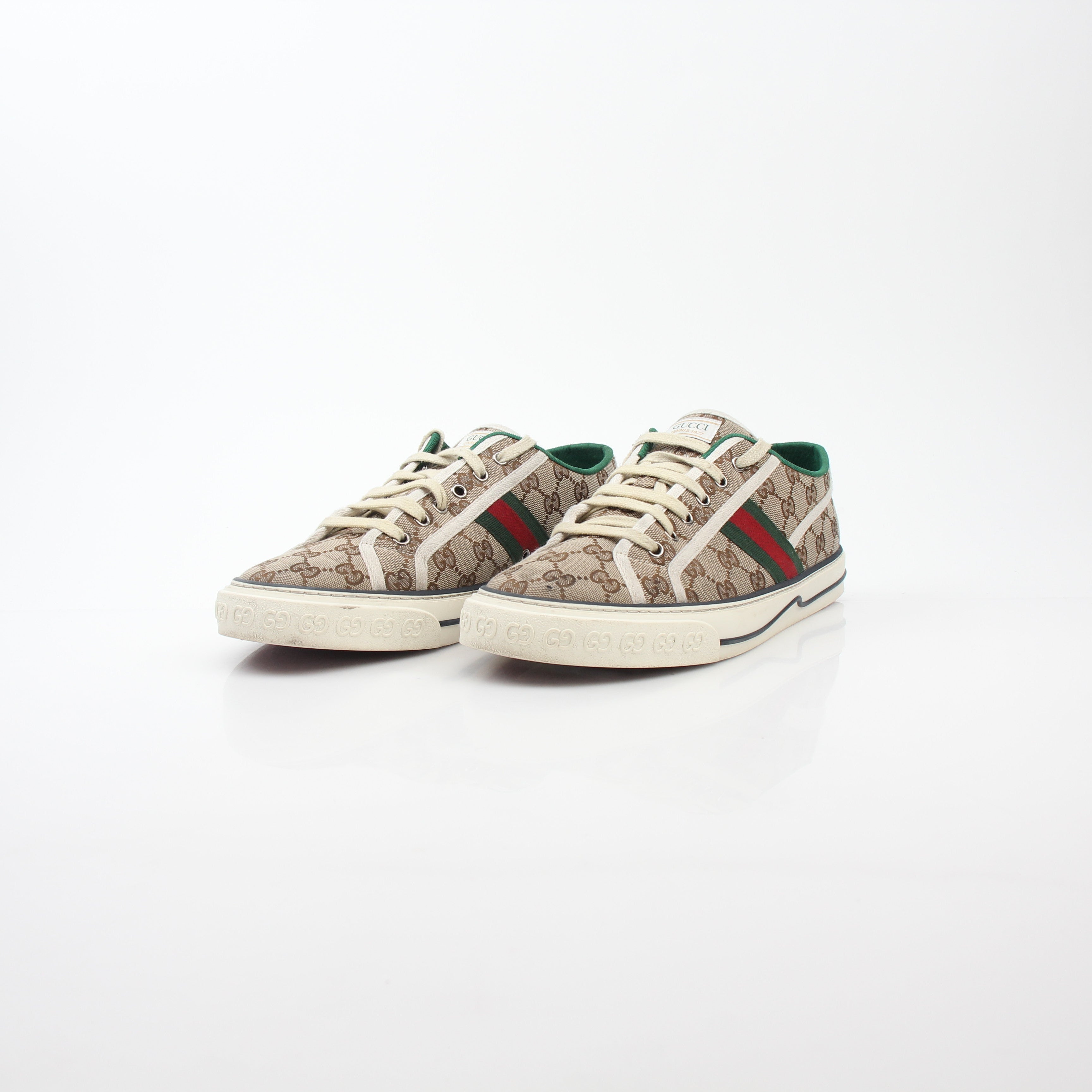 Gold & Beyond Gucci Beige GG Tennis 1977 sneakers, showing classic design with beige canvas and rubber sole detail.