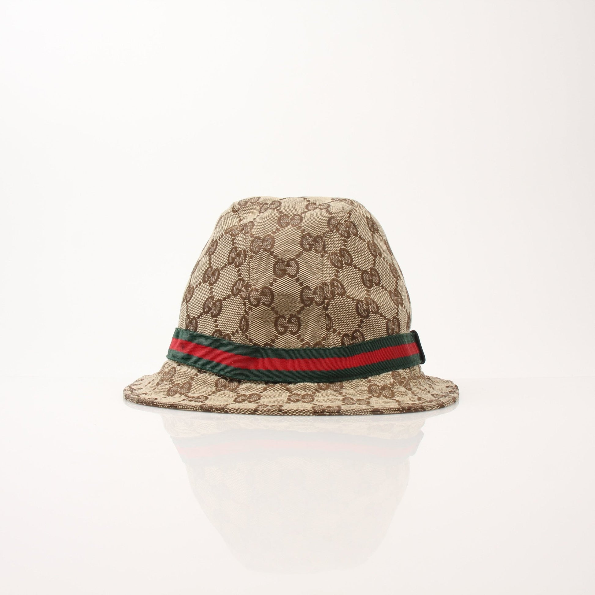 Gucci GG Canvas Bucket Hat in beige and brown with logo pattern, stylish accessories for sun protection and fashion.