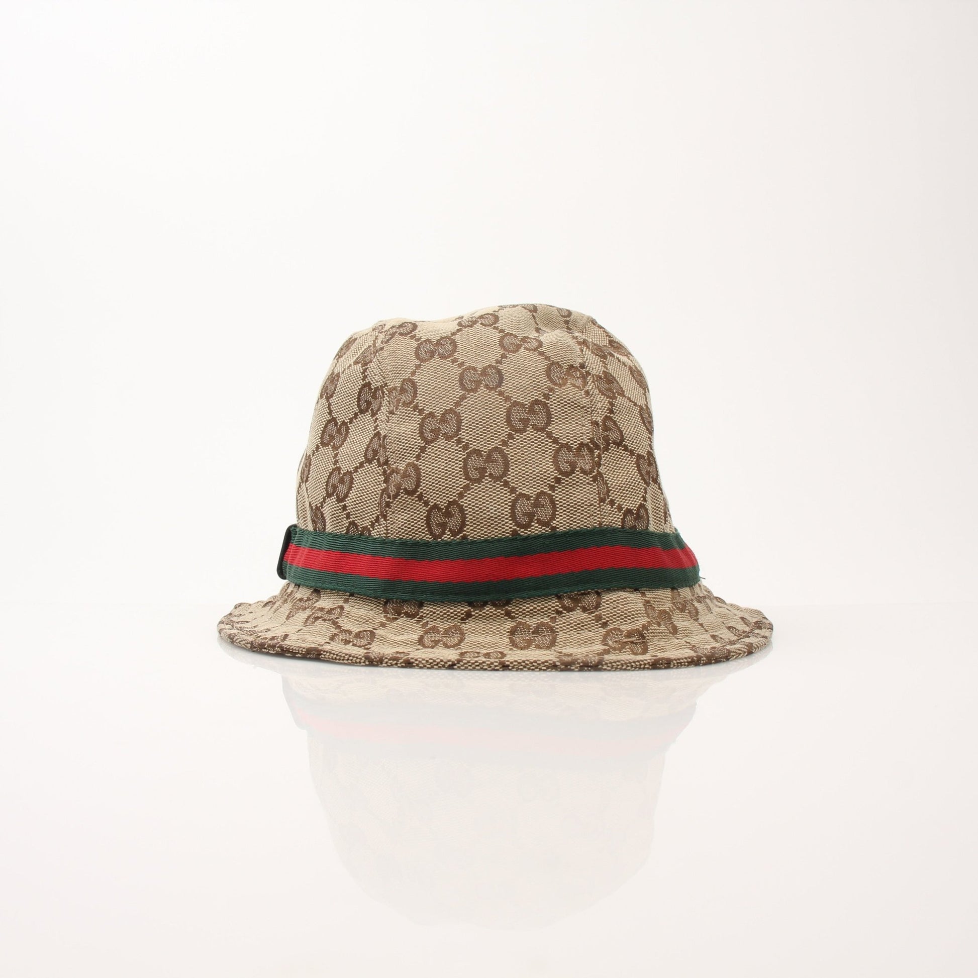Gucci GG canvas bucket hat with gold accents, casual accessories for sun protection and style.