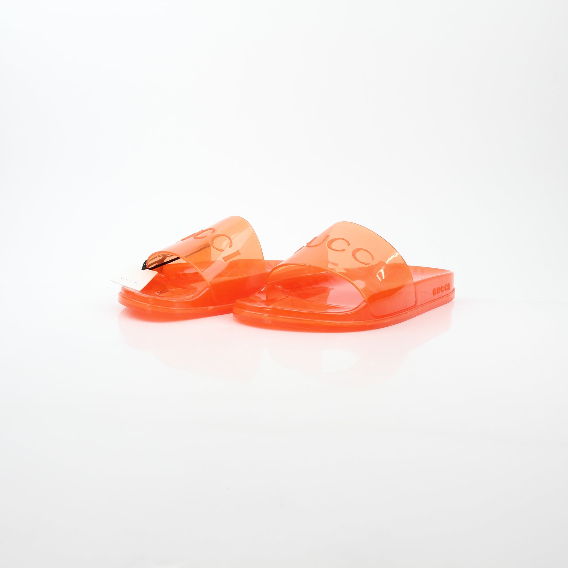 Gucci orange Pursuit logo slide sandals with open toe design and branded strap, displayed on a white background.